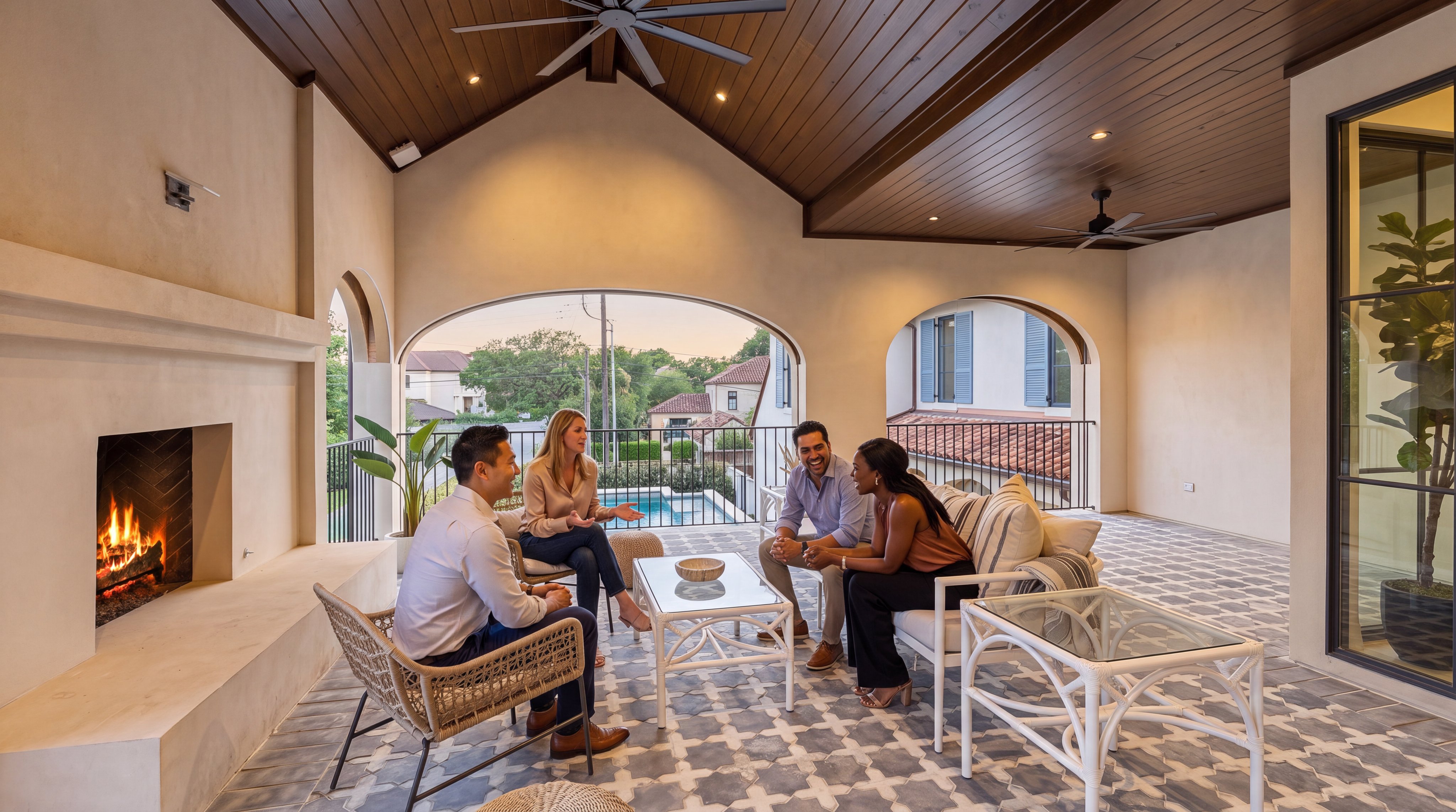 This luxurious covered outdoor terrace features a high vaulted ceiling with rustic wood detailing and built-in lighting. The space offers a sophisticated lounge area complete with a cozy fireplace overlooking a private pool and manicured garden. Its open-air design combined with stylish tile flooring and comfortable seating makes it an ideal spot for refined relaxation and social gatherings.