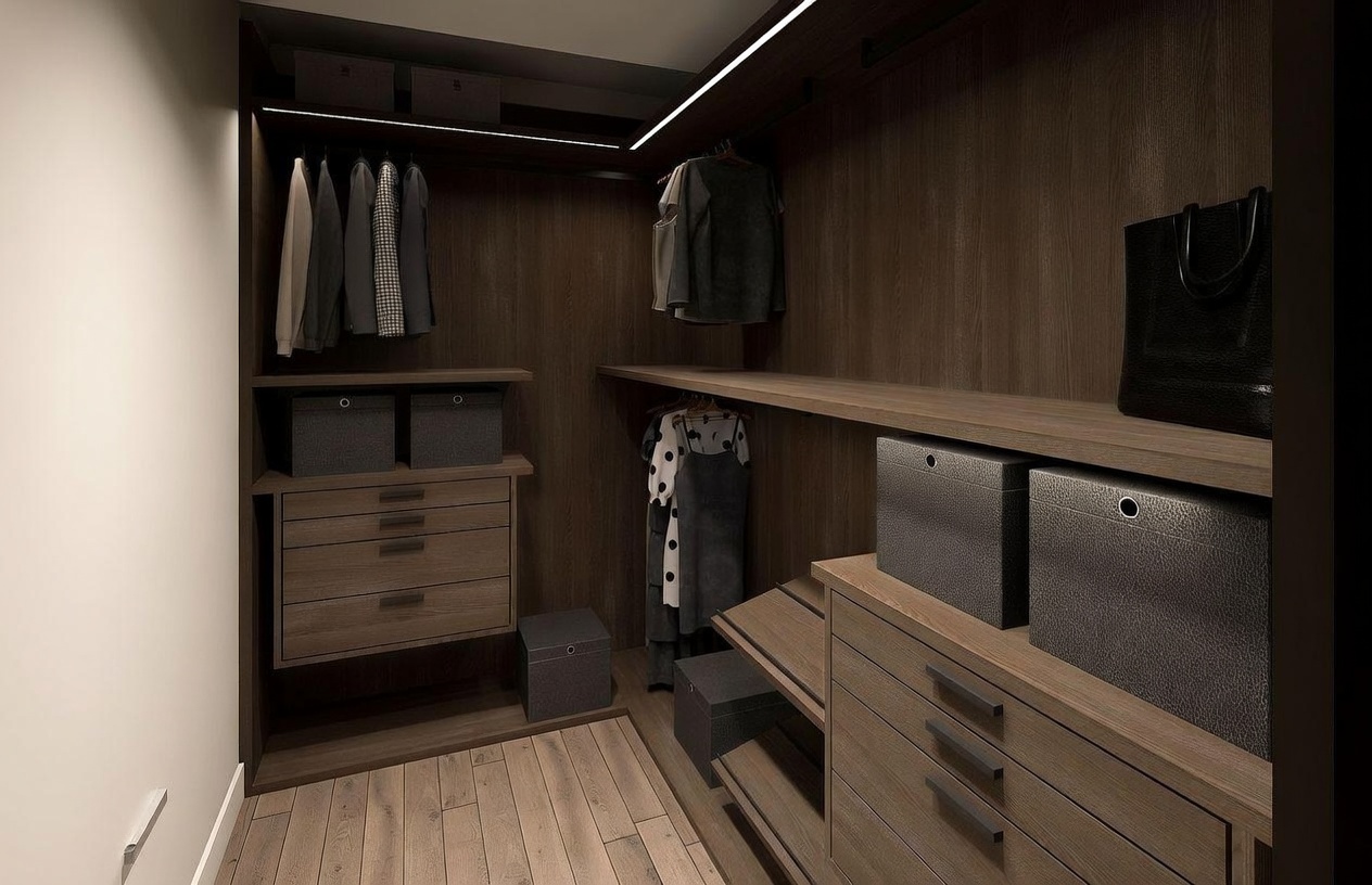 This sophisticated walk-in closet features rich, dark wood cabinetry and integrated LED lighting that highlights the organized storage space. The layout includes a combination of hanging rods, open shelving, and multiple drawers, complemented by dark storage bins for a clean, minimalist aesthetic. The perspective is a straight-on view into the closet, showcasing the warm wood flooring and the efficient use of space for high-end organization.