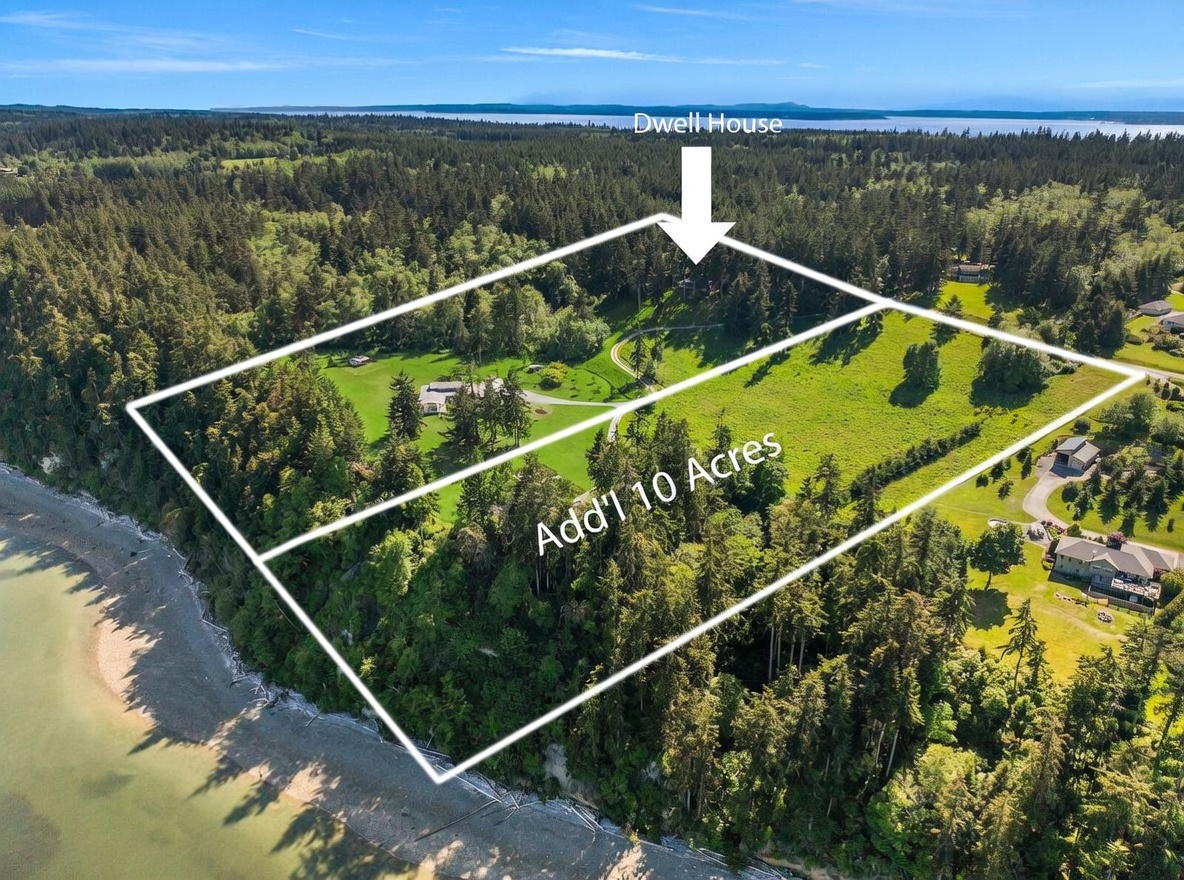 This high-angle aerial view captures a sprawling coastal property featuring a primary residence and an expansive adjacent ten-acre parcel. The landscape is a mix of lush green meadows and dense forest, with a private driveway winding through the grounds toward the shoreline. The perspective highlights the property's significant waterfront access and its secluded, natural setting.