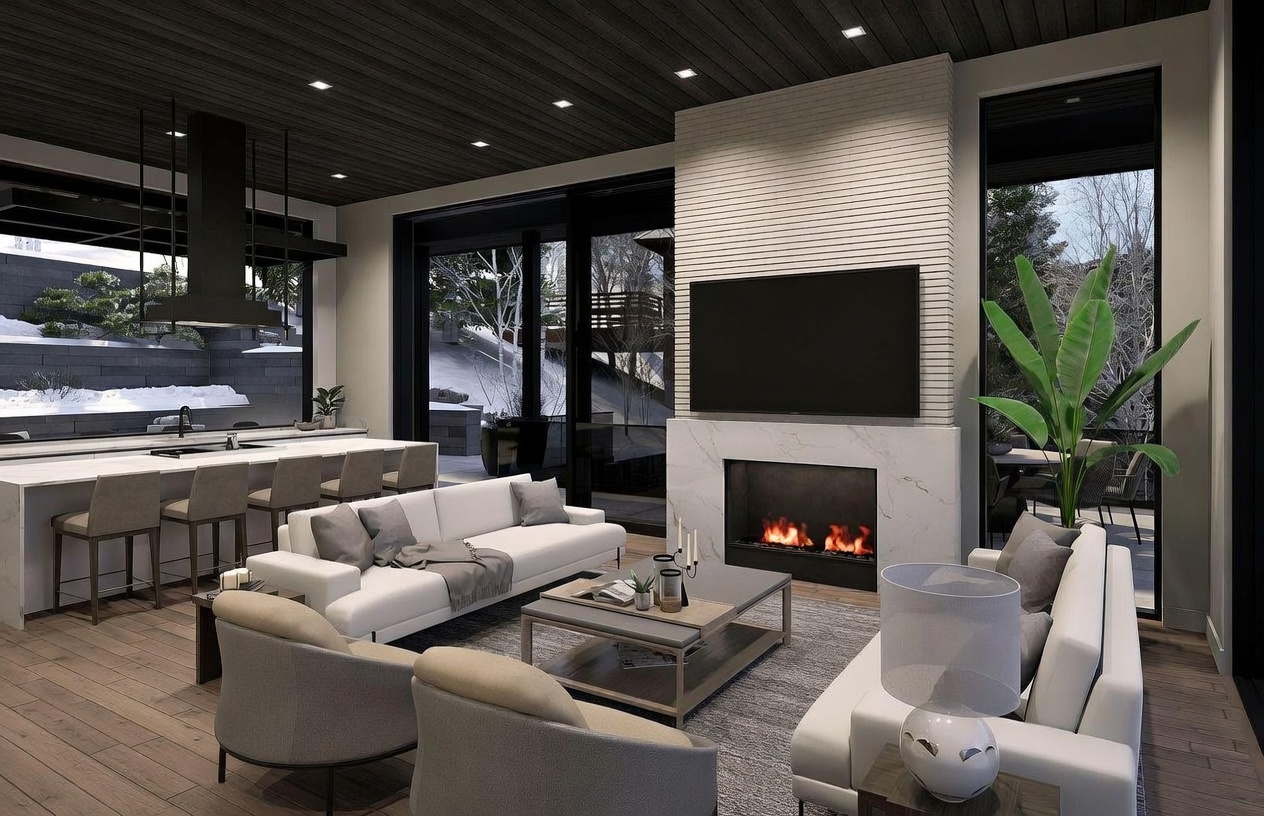 This modern open-concept living area features a sophisticated design with a dark wood-paneled ceiling and large glass sliding doors that provide a seamless connection to the outdoors. A central fireplace with a tall stone-clad chimney breast serves as a focal point, flanked by a comfortable seating arrangement with white sofas and neutral-toned armchairs. The adjacent kitchen area includes a long island with bar seating, creating a cohesive and inviting space for entertaining.
