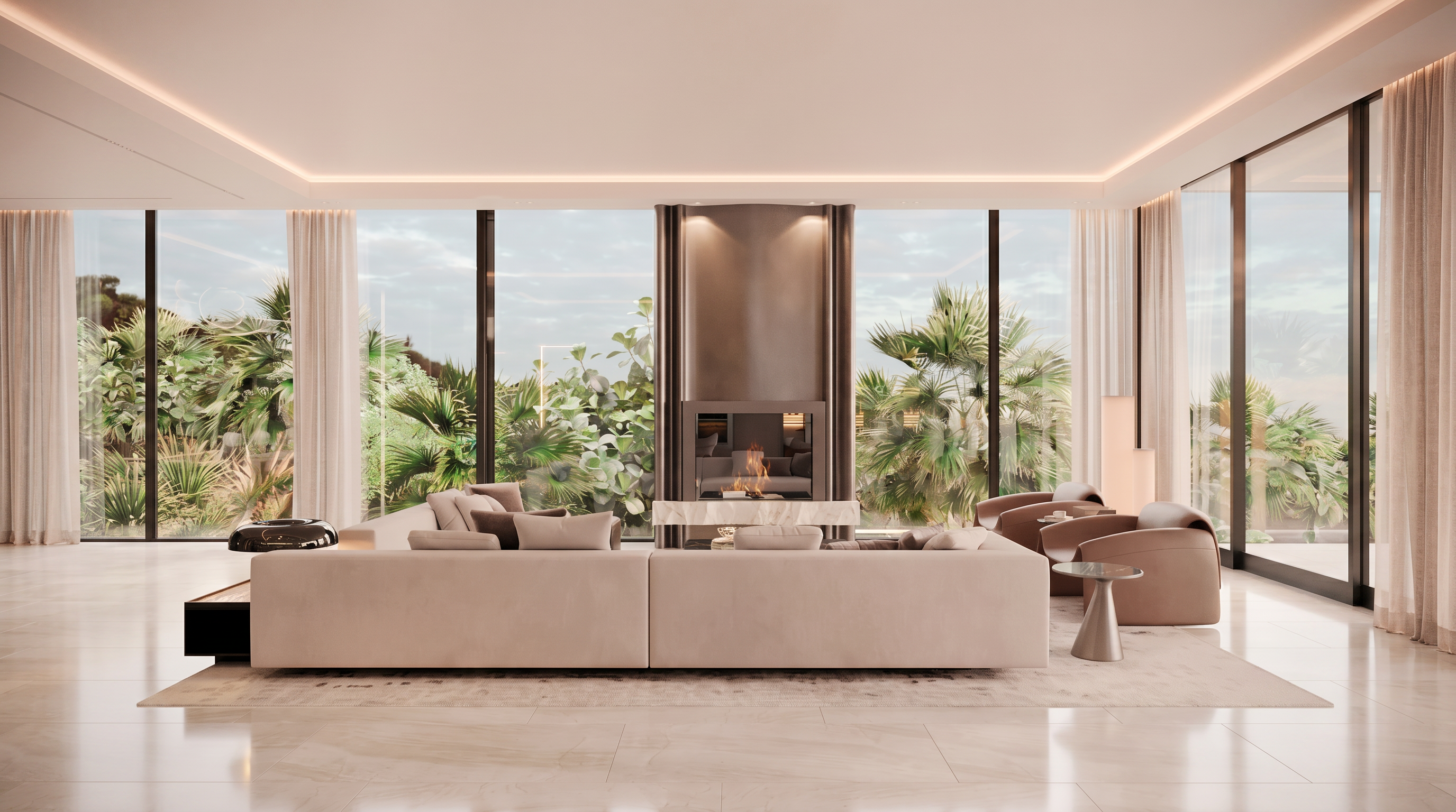 This sophisticated living room features a large, neutral-toned sectional sofa positioned to face a central fireplace with a prominent, dark-toned chimney breast and a stone hearth. The space is framed by expansive, floor-to-ceiling windows that offer a panoramic view of lush tropical greenery outside. The minimalist aesthetic is complemented by sleek, modern armchairs and a small side table, creating an atmosphere of refined luxury and calm.
