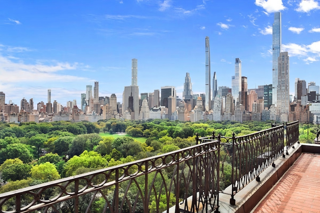 This image captures a sweeping, elevated view of the New York City skyline and Central Park from a private balcony. The foreground features a decorative metal railing with a circular pattern, overlooking a lush, expansive canopy of trees. The perspective is cinematic, showcasing the contrast between the natural greenery of the park and the dense, iconic architecture of the city skyscrapers under a bright blue sky.