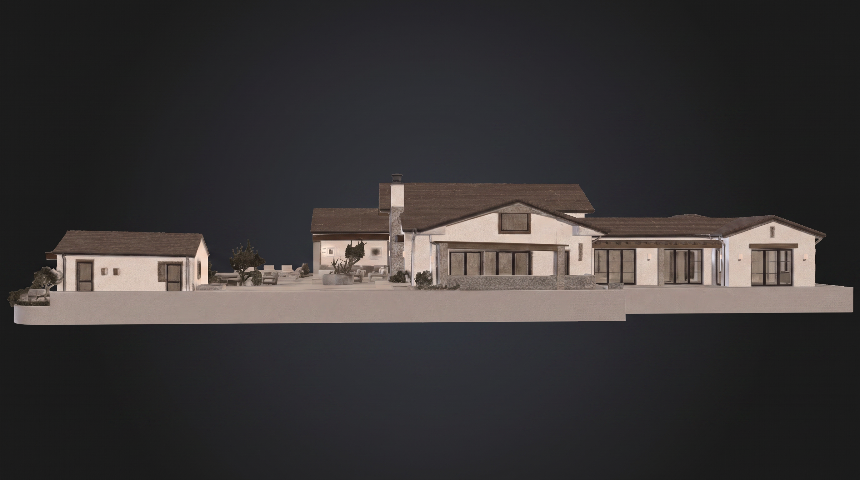 This is a 3D architectural rendering showing the rear elevation of a sprawling, single-story residence. The design features a cohesive, modern farmhouse aesthetic with stucco walls, stone accents, and dark-framed windows and doors, complemented by a landscaped patio area with lounge seating. The layout showcases an expansive design that seamlessly connects indoor living spaces with a private outdoor retreat.