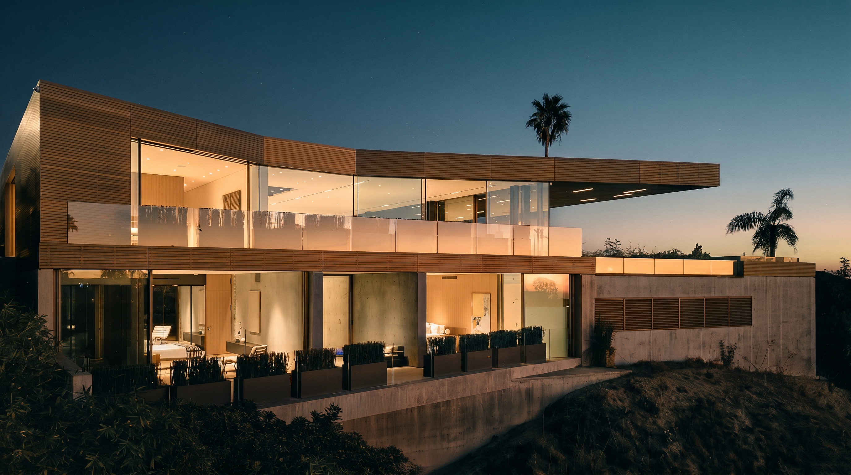 This stunning contemporary architectural masterpiece features a multi-level design with expansive floor-to-ceiling glass walls that seamlessly blend indoor and outdoor living. The structure utilizes a sophisticated mix of warm wood paneling and raw concrete, set against a dramatic twilight sky. The perspective captures the home's elevated position on a hillside, highlighting its sleek cantilevered roofline and illuminated interior spaces.