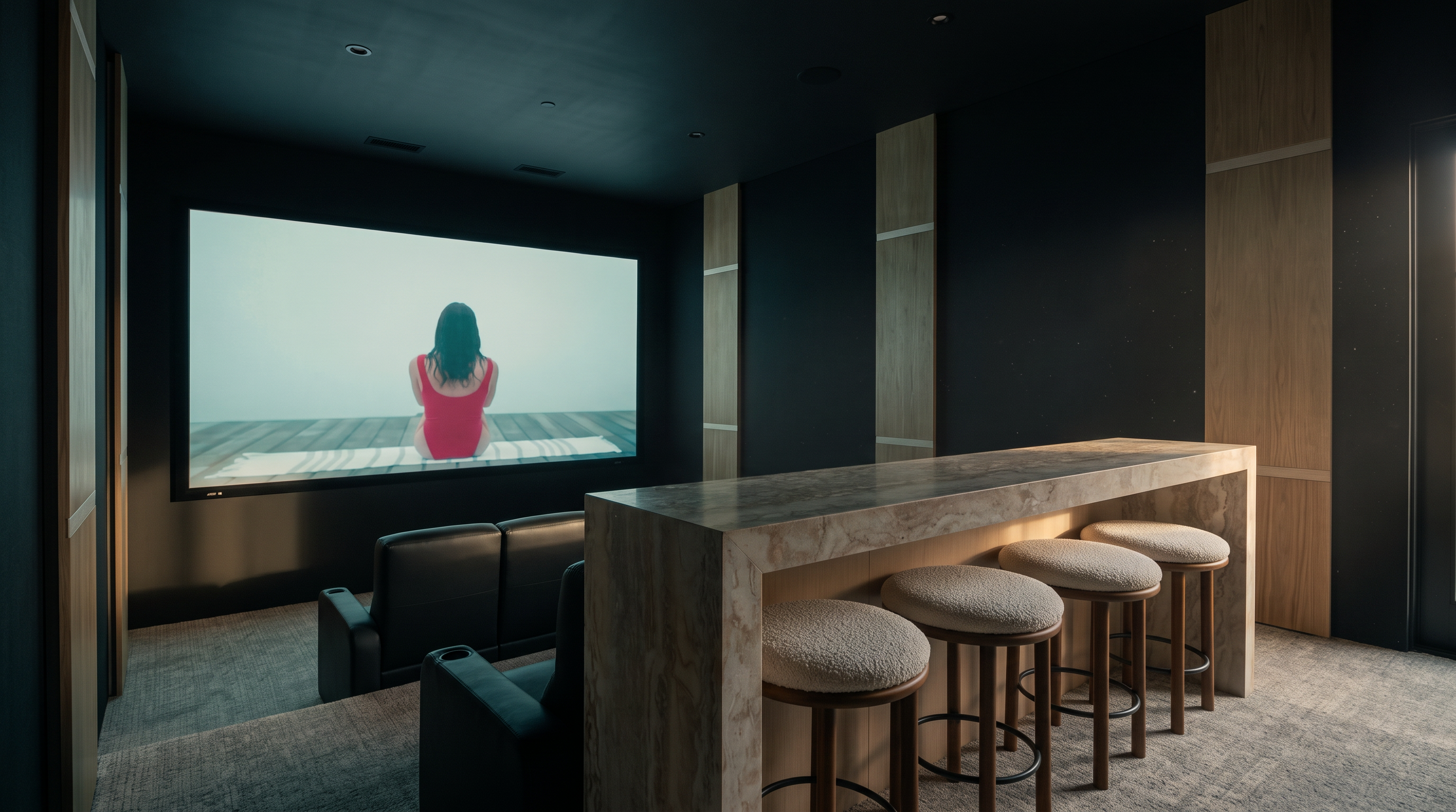 This home theater features a tiered layout with a large projection screen on the front wall and a row of dark leather theater seats. Behind the seating area, a raised bar counter with four upholstered stools provides additional viewing space. The room is accented by vertical light wood panels with integrated LED lighting, creating a sophisticated and modern cinematic atmosphere.