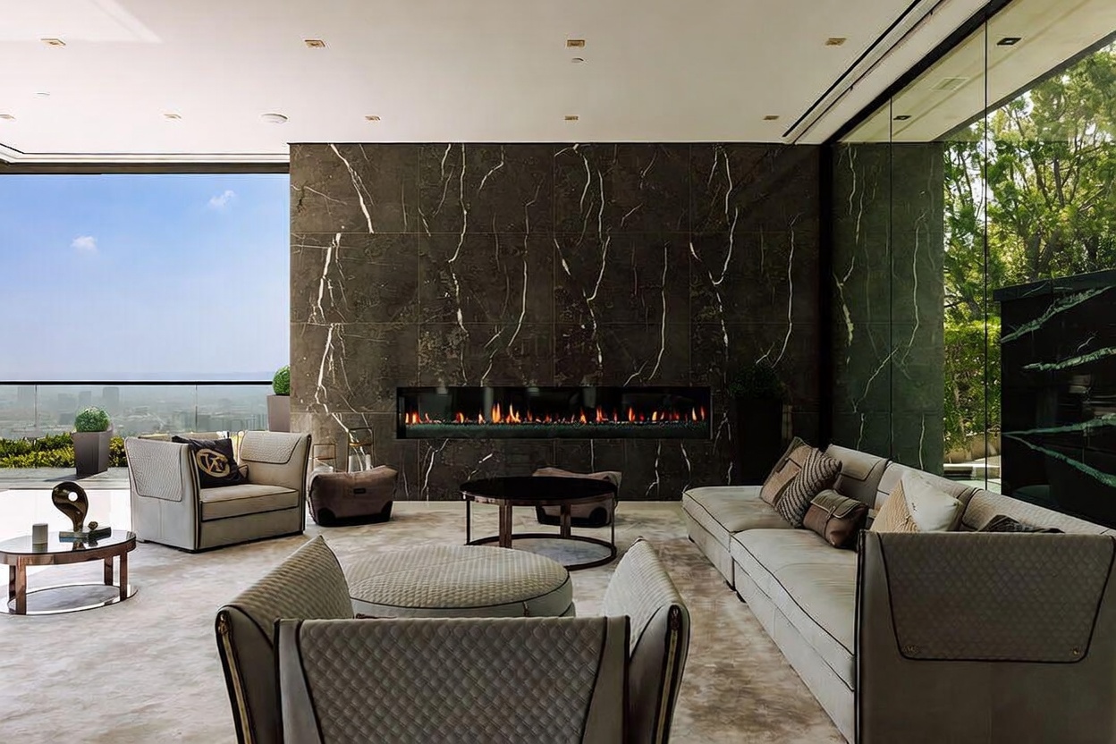 This sophisticated, modern living room features a striking floor-to-ceiling dark marble fireplace wall as its centerpiece, complemented by a long, linear fireplace. The space is furnished with plush, contemporary seating, including a large sectional sofa and elegant armchairs, all arranged on a neutral-toned area rug. Large glass walls provide an expansive, panoramic view of the city skyline, creating a seamless transition between the luxurious interior and the outdoor environment.