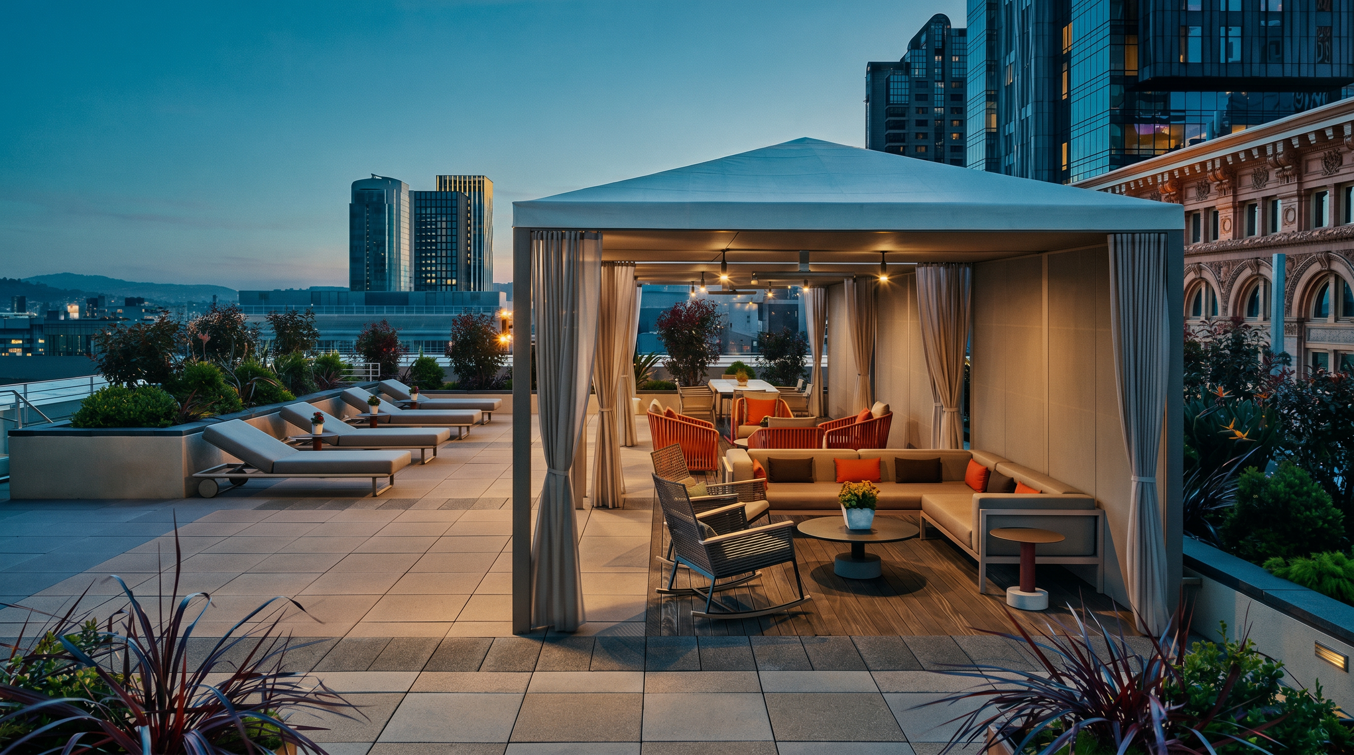 This expansive rooftop terrace offers a sophisticated outdoor lounge area featuring a large, covered cabana with comfortable seating and a rocking chair. Beyond the shaded structure, multiple rows of sleek lounge chairs are arranged on the paved deck, providing ample space for relaxation with a panoramic view of the surrounding city skyline. The setting is modern and upscale, designed for social gatherings or quiet leisure in an urban environment.