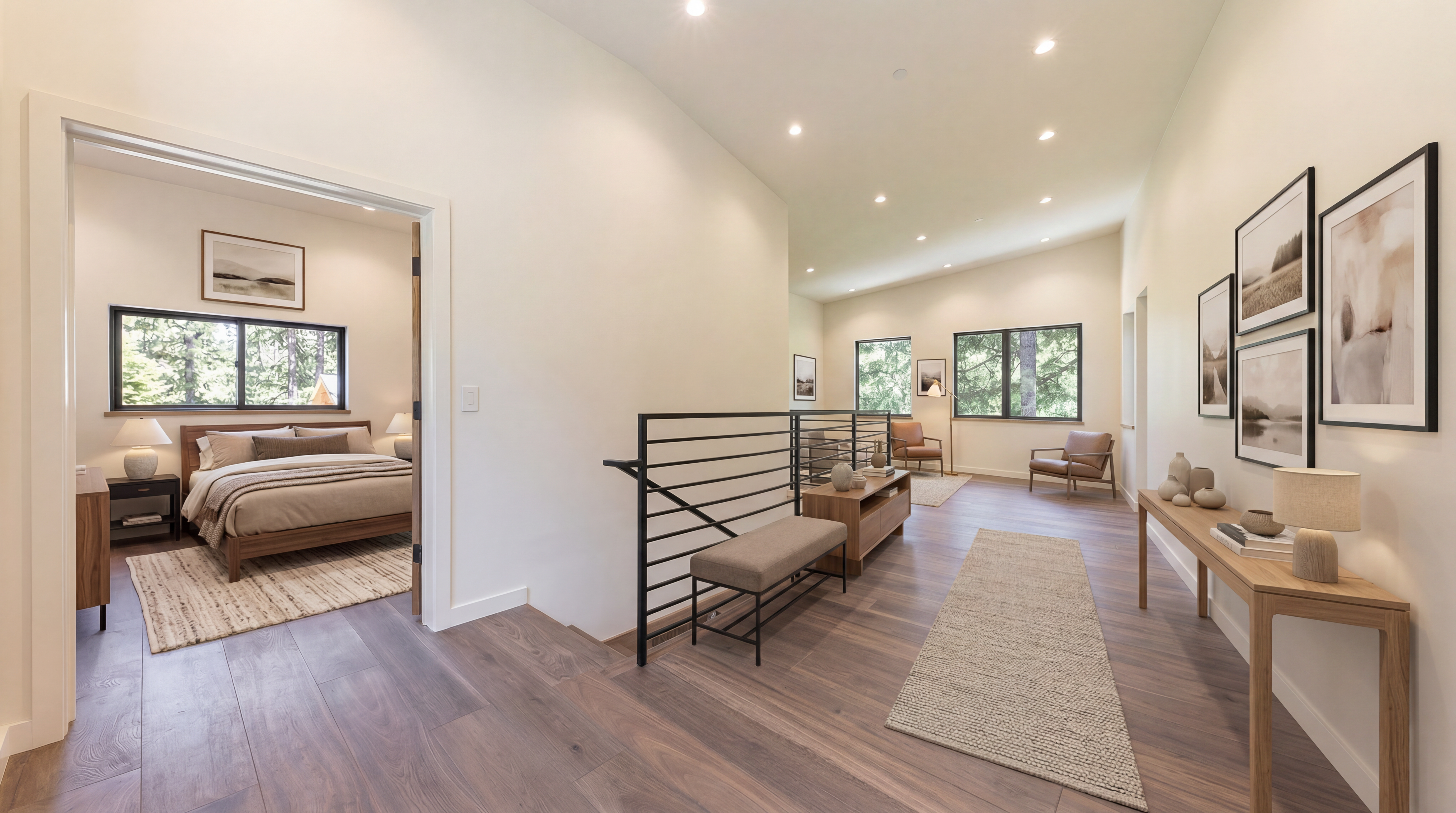 This bright, modern landing area features warm-toned wood flooring and crisp white walls, creating an airy and open atmosphere. A black metal railing with horizontal bars provides a sleek, industrial-inspired safety barrier for the staircase, while large windows allow natural light to flood the space. The perspective captures the transition between the hallway and an adjacent room, highlighting the clean lines and minimalist architectural design.