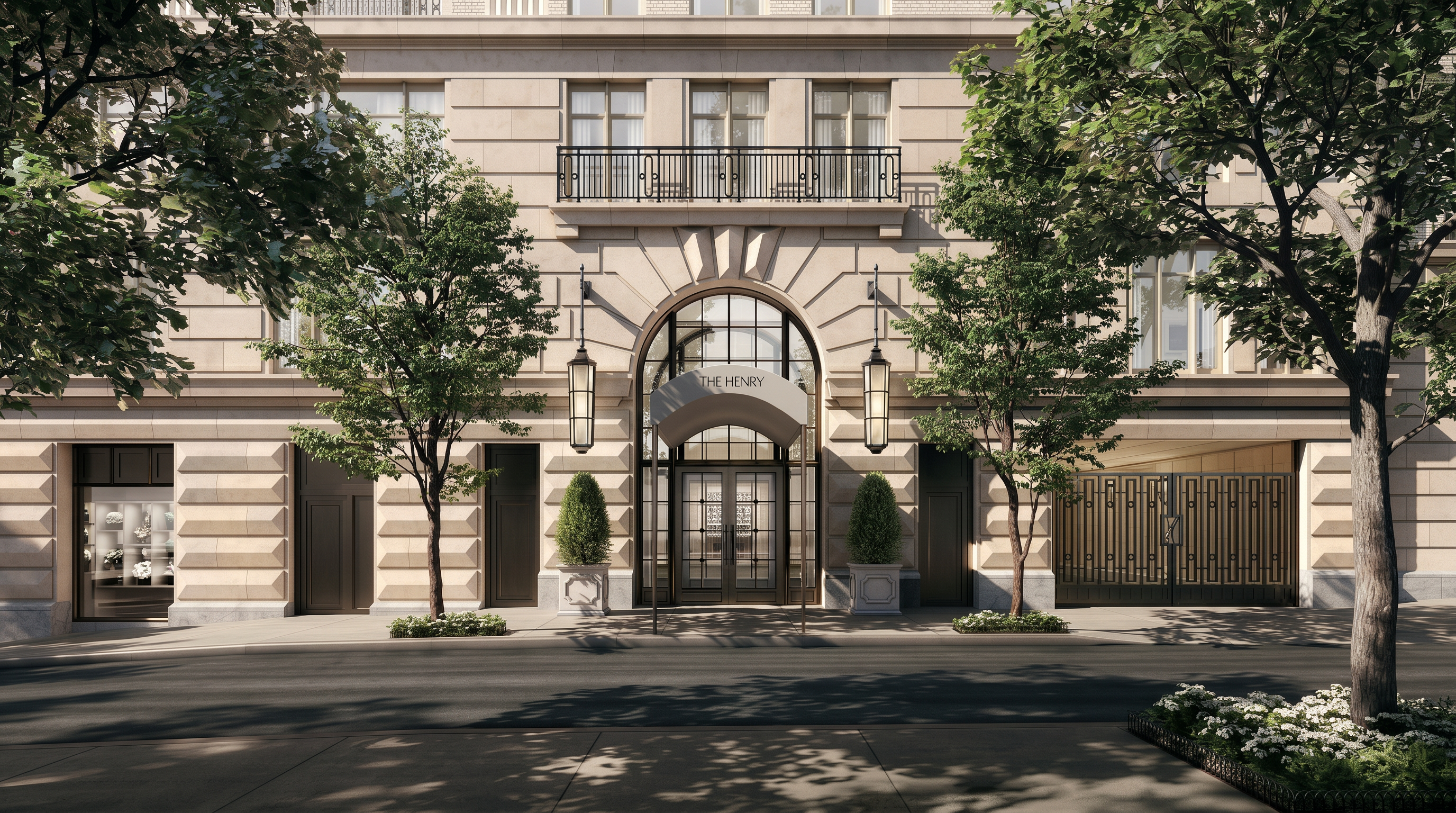 This eye-level, cinematic shot captures the grand, symmetrical entrance of 'The Henry,' a sophisticated building with a classic stone facade. The central arched doorway is flanked by elegant hanging lanterns and manicured topiary, while a wrought-iron gate to the right provides access to a private garage area. The composition is framed by lush, mature trees in the foreground, creating a refined and welcoming street-level perspective.
