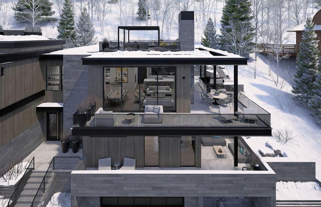 This high-angle aerial view showcases a modern, multi-level mountain residence nestled in a snowy, wooded landscape. The home features a contemporary design with clean lines, extensive glass walls, and multiple tiered terraces equipped with outdoor seating and dining areas. A prominent stone-clad chimney rises through the structure, which is complemented by dark wood siding and a rooftop deck.