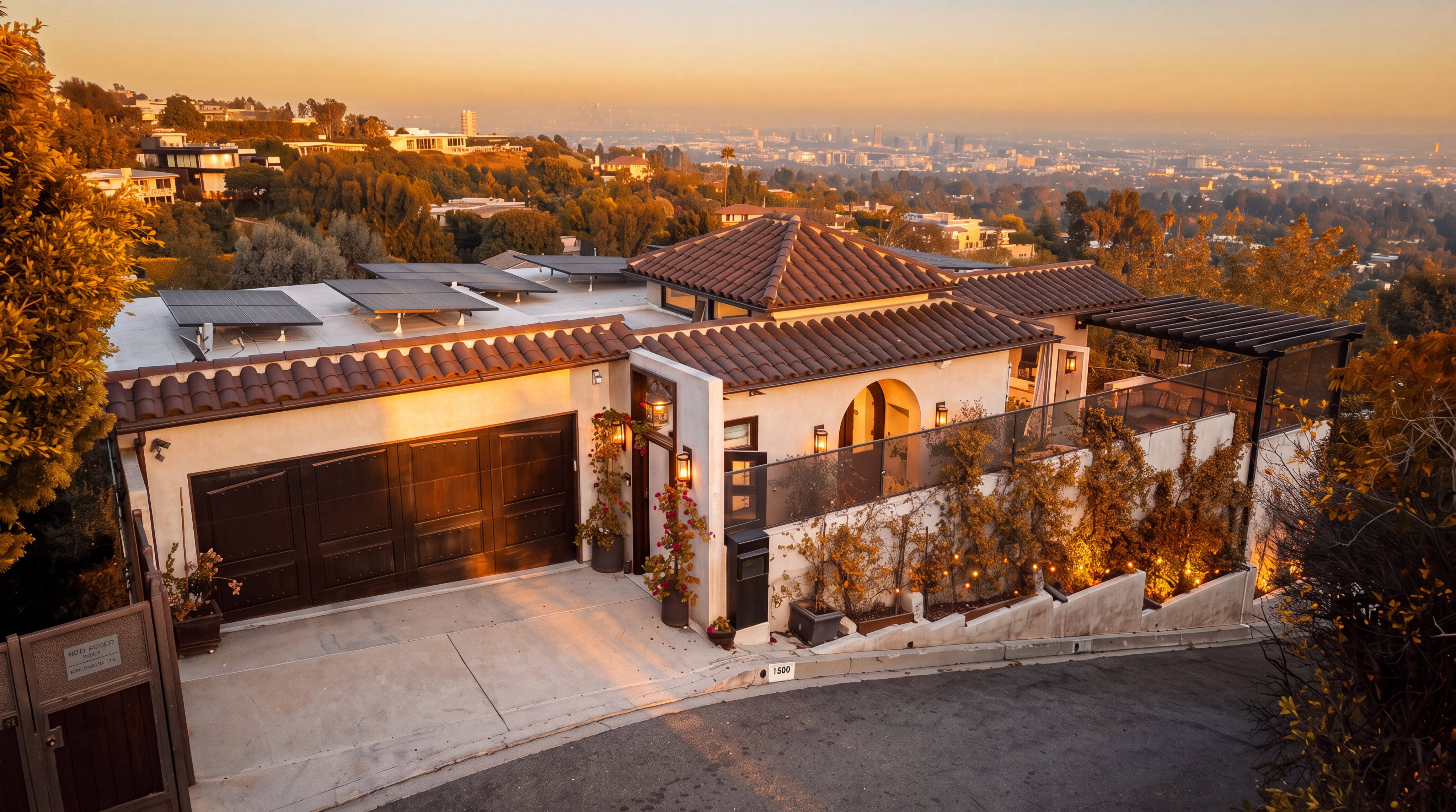 This stunning contemporary villa features a multi-tiered tile roof and solar panels, set against a breathtaking panoramic city backdrop at sunset. The property includes a spacious two-car garage, manicured climbing vines, and a welcoming front entrance with warm ambient lighting. Its elevated hillside location offers both privacy and a prestigious, modern aesthetic perfect for luxury living.