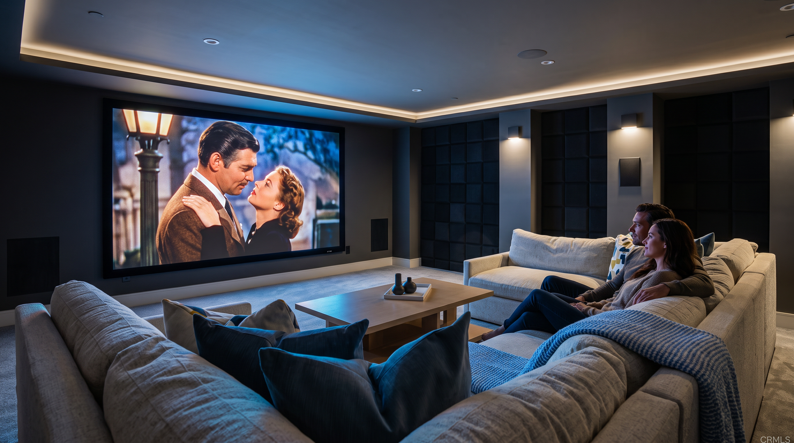This luxurious home theater room is designed for comfort and cinematic enjoyment, featuring a large projection screen displaying a classic film and a spacious, modern sectional sofa. The room is accented by atmospheric cove lighting, minimalist black wall paneling, and a contemporary coffee table, creating an inviting and sophisticated media space. The overall design emphasizes a cozy yet high-end entertainment experience.