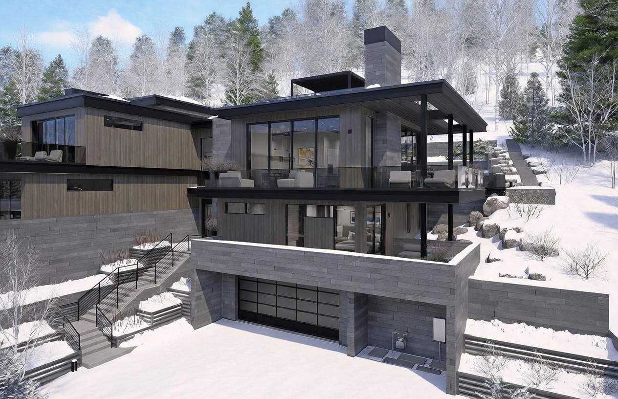 This modern mountain residence features a striking architectural design with a multi-level facade composed of dark wood siding and textured stone cladding. The home includes a spacious garage, a large elevated deck with glass railings, and a prominent stone-clad chimney breast rising above the roofline. Set against a snowy, wooded hillside, the property showcases a contemporary aesthetic with clean lines and expansive glazing that integrates the structure into the winter landscape.