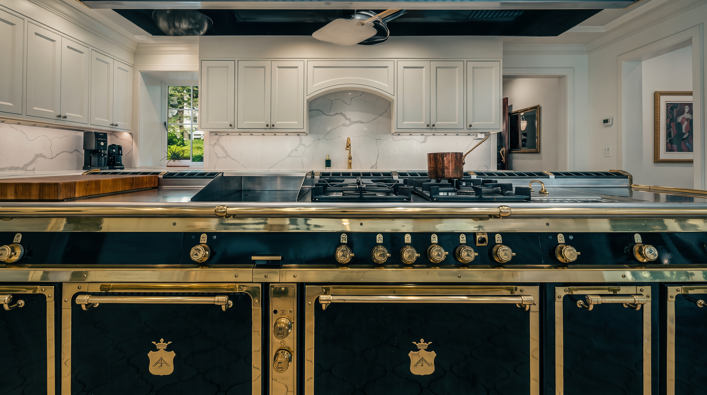 This high-end kitchen features a massive, professional-grade range with a striking black and brass finish as the central focal point. The space is equipped with white cabinetry, a light-colored stone backsplash, and a large stainless steel countertop, creating a sophisticated and luxurious culinary environment. The perspective is a straight-on, eye-level shot that emphasizes the symmetry and grandeur of the custom range and the detailed metalwork of the overhead ventilation hood.