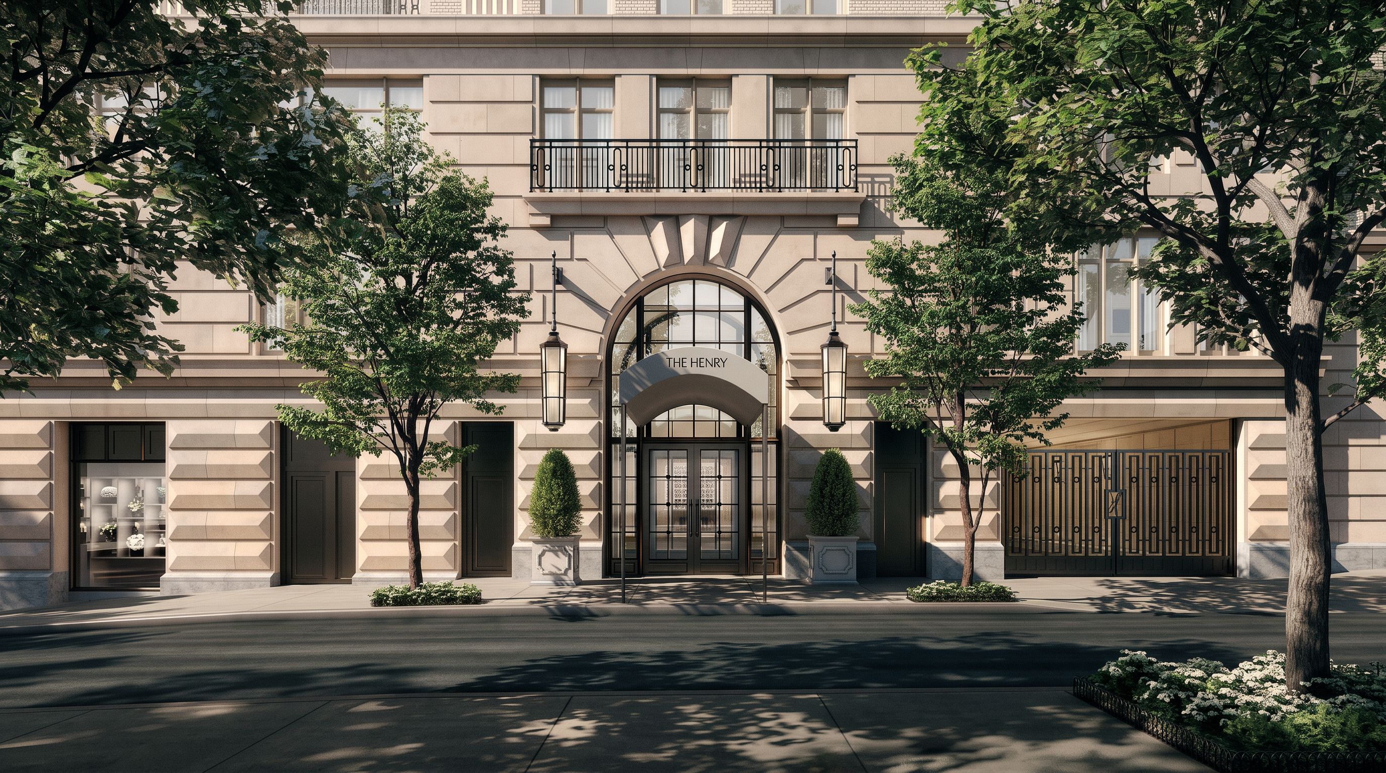 This eye-level exterior shot captures the grand, symmetrical facade of 'The Henry,' a sophisticated building with classical architectural influences. The central arched entryway is flanked by elegant lanterns and manicured topiary, leading to a glass-paneled door, while large windows and a wrought-iron balcony add to the refined aesthetic. The scene is framed by lush green trees on either side, creating a welcoming and prestigious street-level perspective.