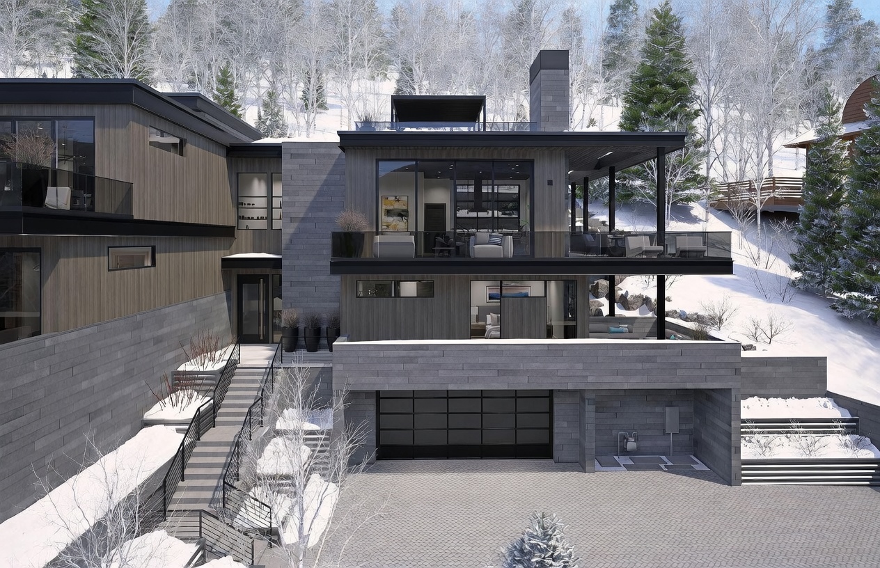 This modern mountain residence features a sophisticated blend of dark wood siding and textured stone masonry, set against a snowy, forested backdrop. The multi-level design includes a spacious garage, a prominent stone-clad chimney, and expansive balconies with glass railings that offer seamless indoor-outdoor living. The perspective is an elevated exterior view, highlighting the home's architectural integration into the sloped, winter landscape.