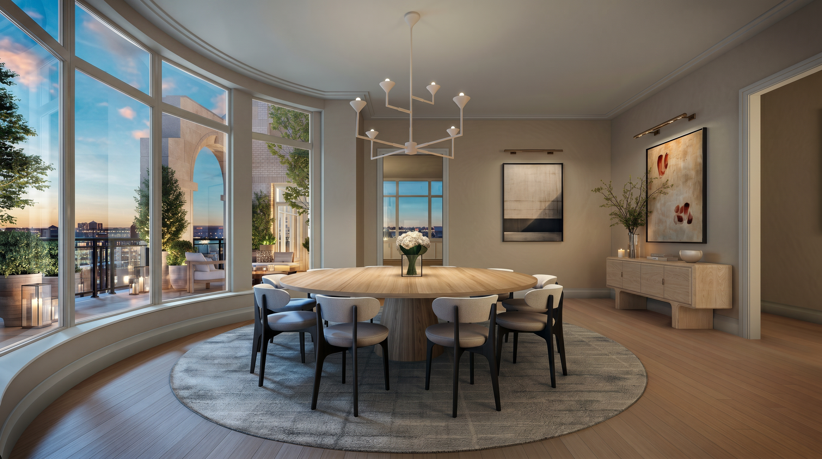 This elegant dining room features a large, circular light wood table centered on a circular area rug, surrounded by modern chairs with dark frames and light upholstery. A striking, multi-armed white chandelier hangs above the table, while a light wood sideboard sits against the wall adorned with abstract artwork. The room is bathed in natural light from expansive, curved windows that offer a panoramic view of an outdoor terrace and the city skyline beyond.