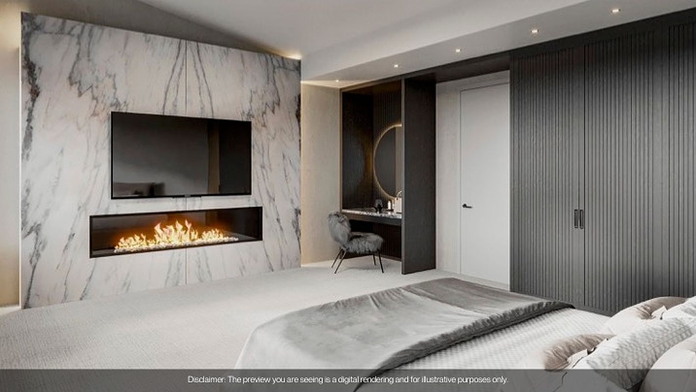 This is a luxurious primary bedroom featuring a modern design with a marble accent wall, a sleek fireplace, and a large flat-screen TV. The room includes a vanity area with a round mirror and a comfortable chair, as well as a spacious wardrobe with textured doors. The bed is neatly made with neutral-toned linens, creating a serene and inviting atmosphere.