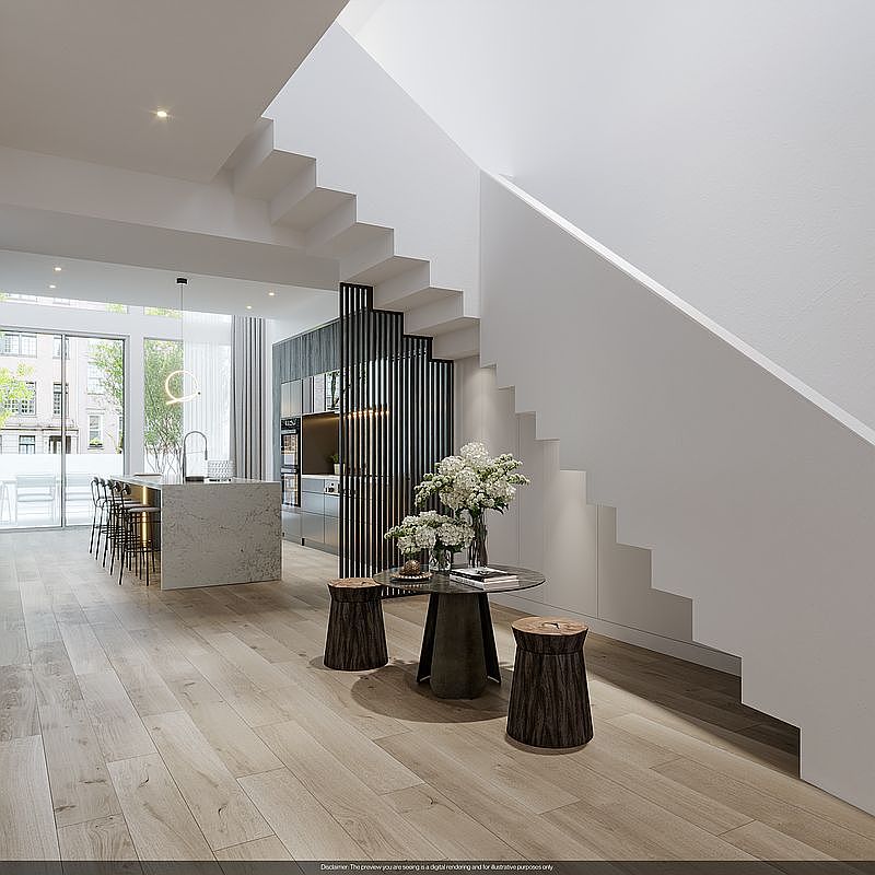 This interior shot showcases a modern hallway and staircase. The staircase features a unique design with open risers and a minimalist railing, complemented by a sleek, contemporary kitchen in the background. The space is well-lit and airy, creating a welcoming and stylish atmosphere.