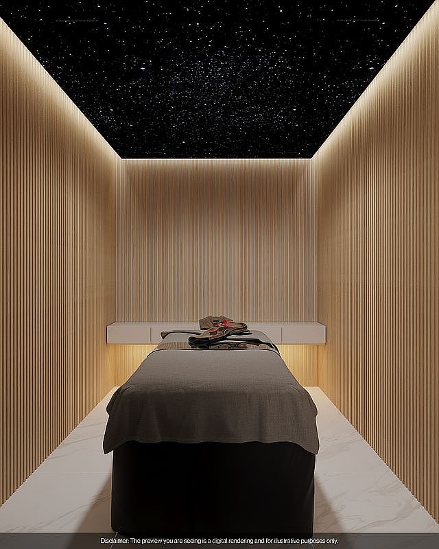 The image showcases a modern and serene bedroom interior, featuring a massage bed as the focal point. The walls are adorned with vertical wooden panels, complemented by subtle lighting that enhances the room's ambiance. The ceiling is designed with a star-like pattern, creating a calming and luxurious atmosphere, ideal for relaxation and wellness.