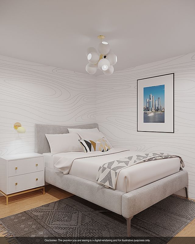 This is a bedroom featuring a bed with a light gray upholstered frame and headboard, white bedding, and a decorative pillow. A white nightstand with gold accents sits beside the bed, and a framed picture hangs on the wall. The room is decorated in a modern style with a neutral color palette and patterned wallpaper.