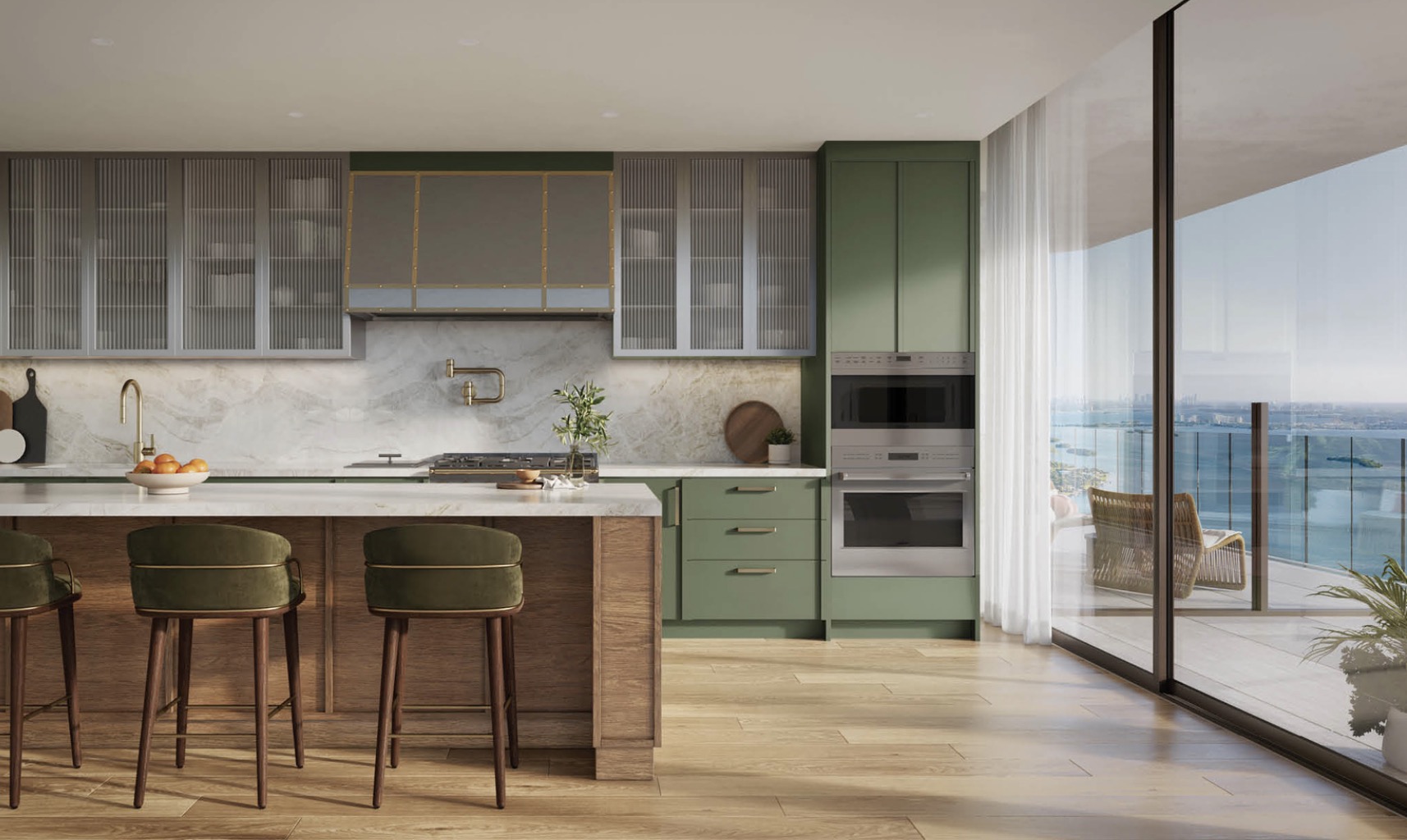 This is a modern kitchen with a large island and bar stools. The kitchen features a combination of green and gray cabinets, stainless steel appliances, and a marble backsplash. Large sliding glass doors open to a balcony with a view of the water.