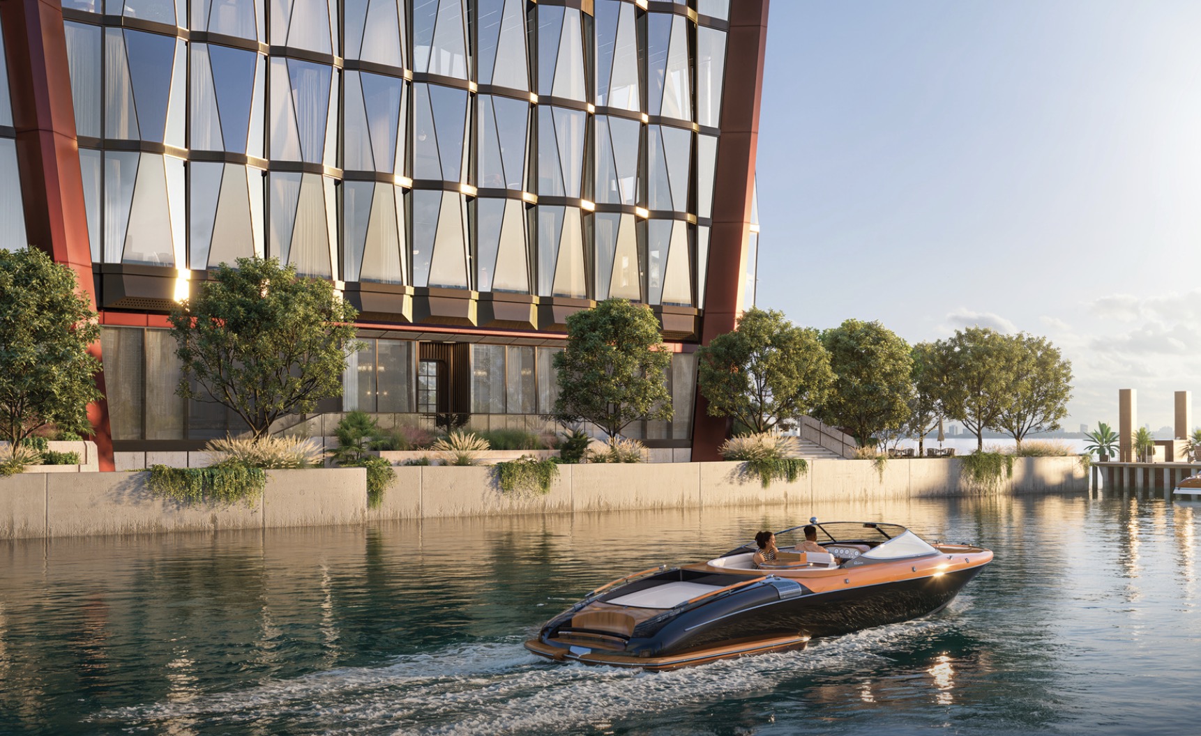 This image showcases a modern building with distinctive architectural features, including a facade of geometric windows and a striking red accent structure. A sleek boat glides on the water in front of the building, adding a sense of luxury and waterfront access. Lush greenery lines the waterfront, enhancing the property's appeal.