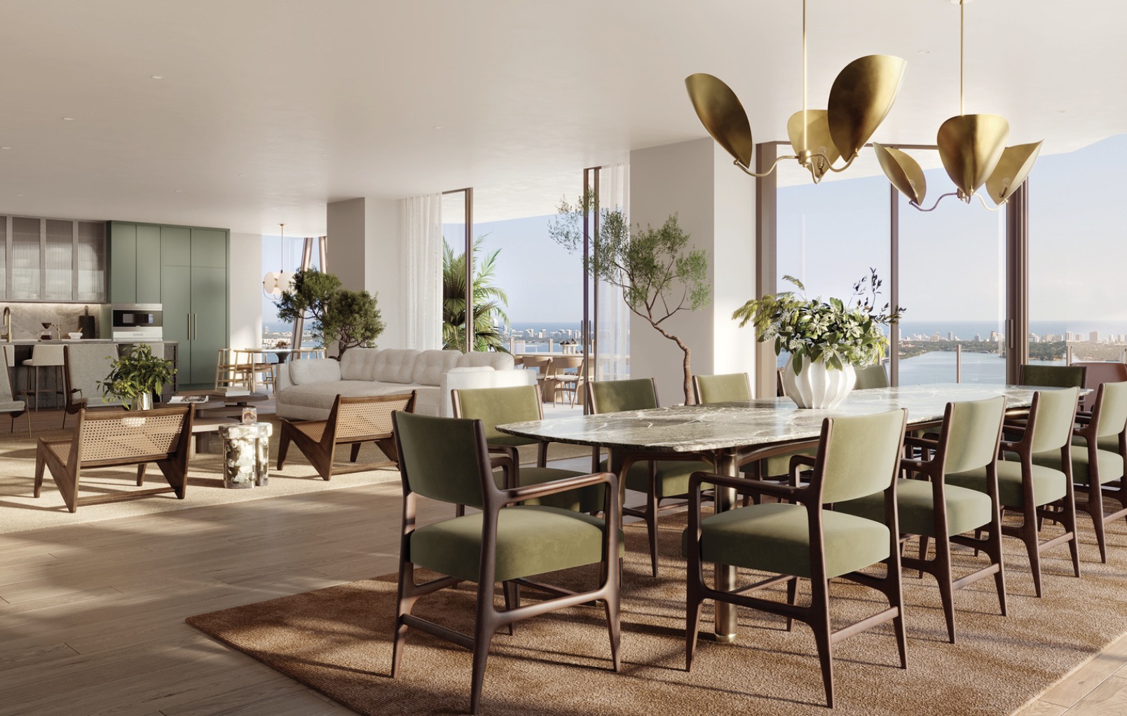 This is a bright and airy interior shot showcasing a modern dining room that seamlessly blends into a living space. The dining area features a large marble-topped table surrounded by olive green upholstered chairs, illuminated by a unique gold chandelier. The open floor plan includes a living area with a white sofa and stylish accent chairs, all complemented by natural light streaming through expansive windows offering a stunning view of the cityscape and ocean.