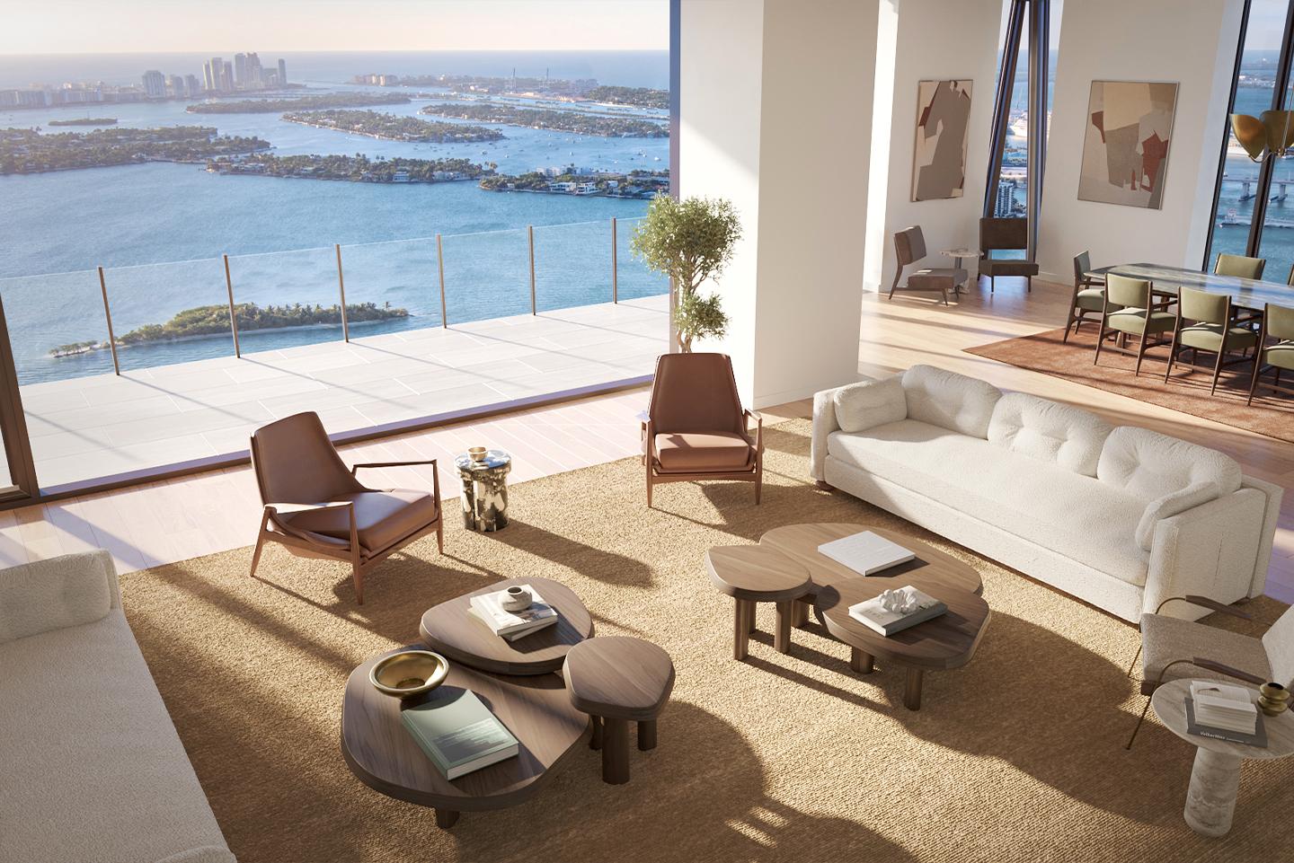 This is a bright and airy living room with a stunning ocean view. The room features modern furniture, including a large white sofa, several unique coffee tables, and stylish armchairs. The neutral color palette and natural light create a serene and luxurious atmosphere, perfect for relaxation and entertaining.