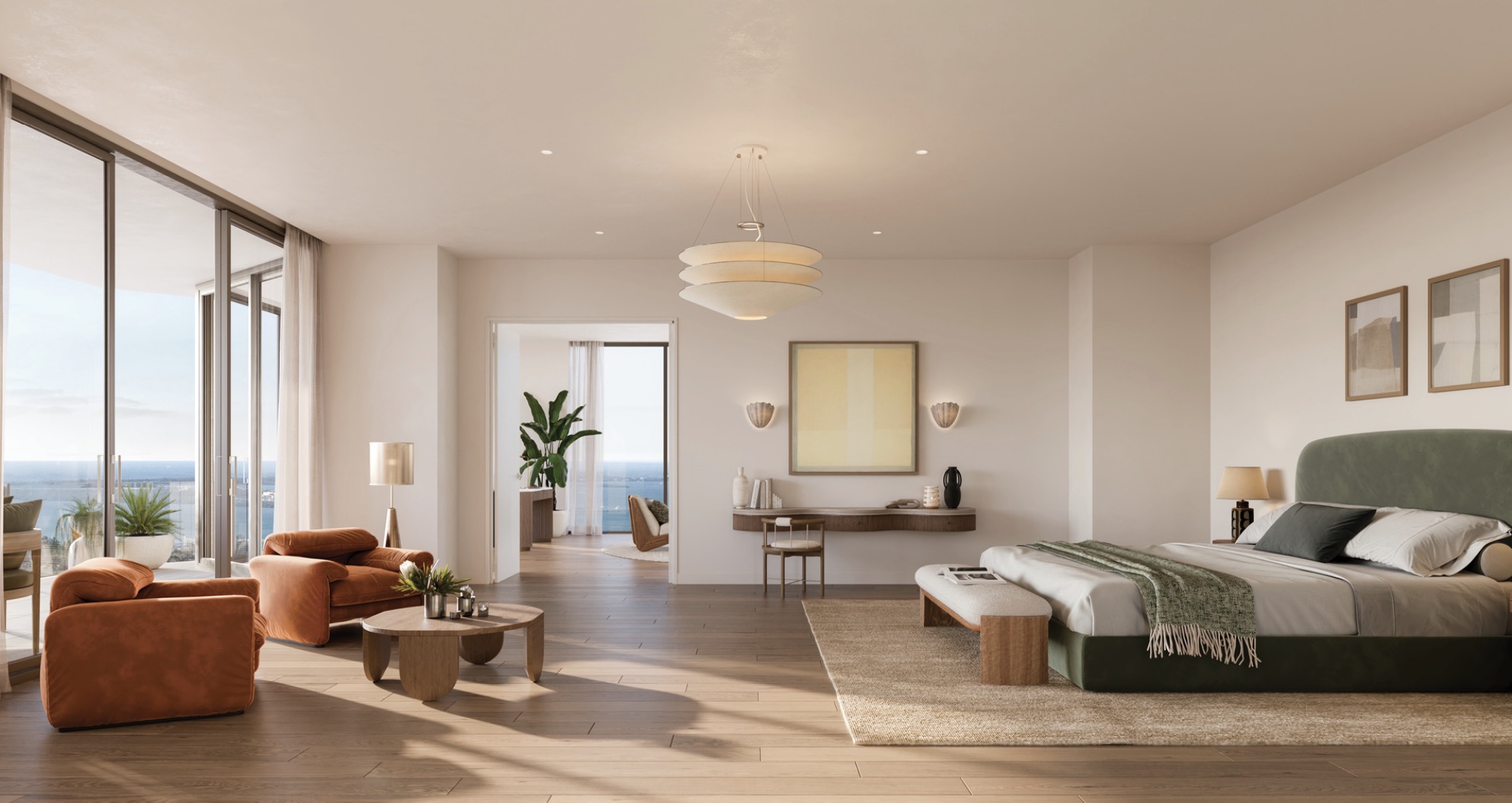 This is a spacious primary bedroom featuring a king-size bed with a green headboard, a seating area with two armchairs, and a desk area with artwork. The room has large windows offering a view, hardwood floors, and a neutral color palette, creating a serene and luxurious atmosphere. The room is well lit with natural light and the perspective is from the doorway.