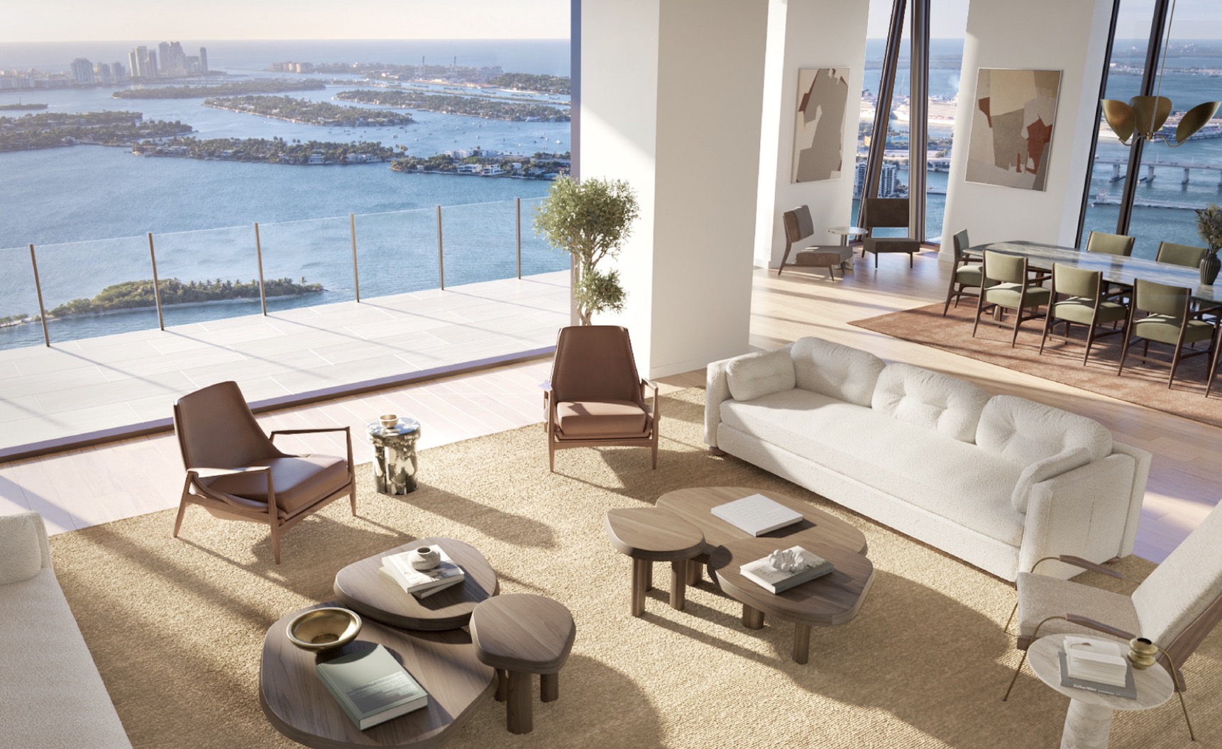 This is a luxurious living room with modern furnishings, including a plush white sofa, unique wooden coffee tables, and stylish armchairs. Large windows offer stunning ocean views, enhancing the room's bright and airy atmosphere. The space is designed for comfort and elegance, perfect for relaxation and entertaining.
