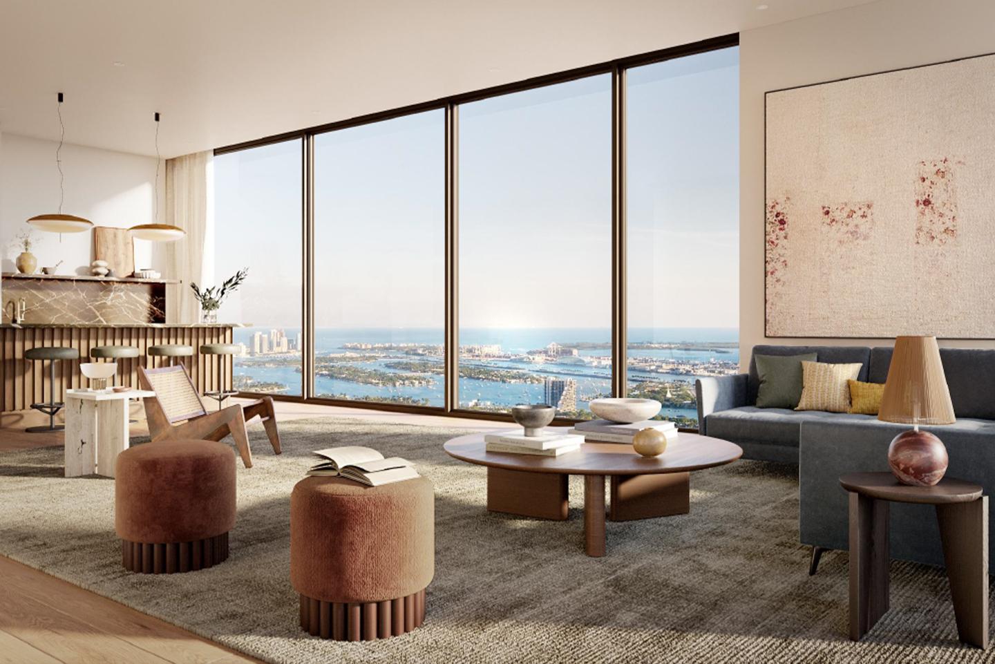 This is a luxurious living room with floor-to-ceiling windows offering panoramic ocean views. The room features a modern design with a neutral color palette, comfortable seating, and stylish decor. The open layout and natural light create a spacious and inviting atmosphere, perfect for relaxation and entertaining.
