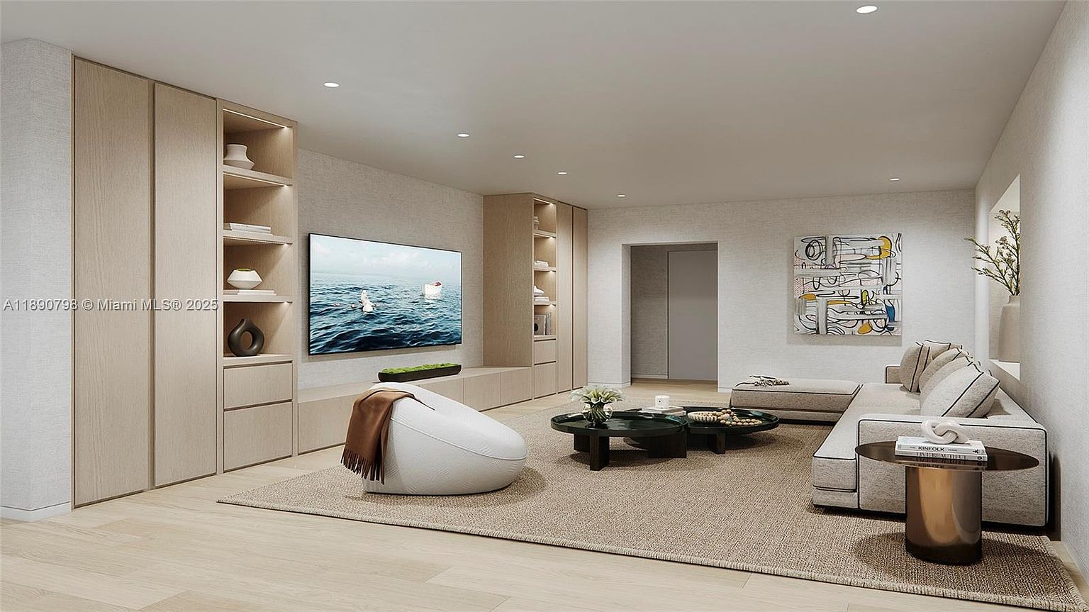 This is a living room featuring a neutral color palette with light wood flooring and textured walls. Built-in cabinetry surrounds a large television, and a comfortable sectional sofa anchors the space. The room is well-lit with recessed lighting and natural light, creating a serene and inviting atmosphere.