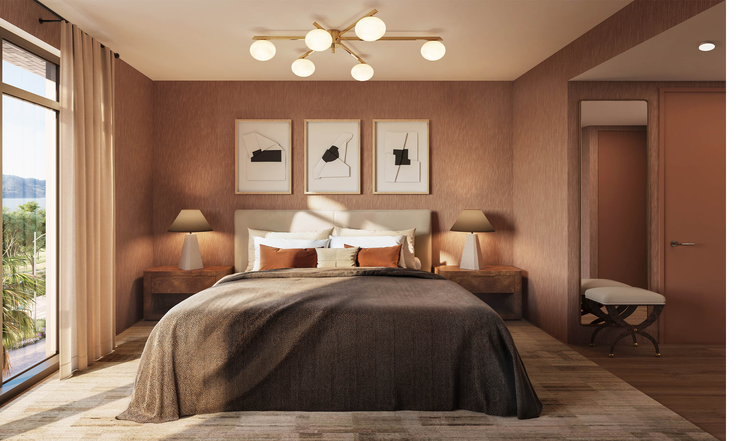 This is a beautifully staged primary bedroom featuring a large bed with a brown patterned cover, flanked by matching nightstands and lamps. Three framed art pieces hang above the bed, and a modern chandelier provides ambient lighting. A bench sits near a doorway, and a large window offers natural light, creating a warm and inviting atmosphere.