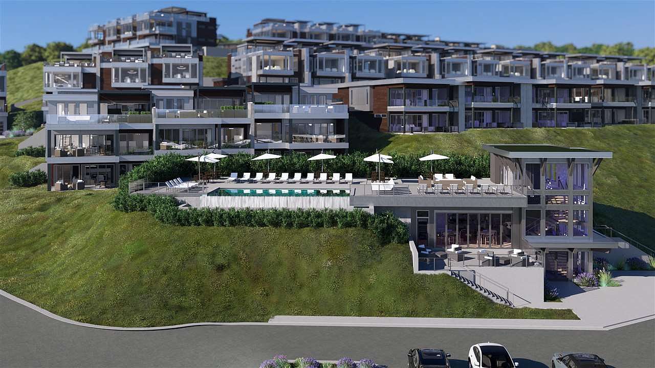 This image showcases a luxurious residential complex with a focus on its outdoor amenities. A pristine pool is surrounded by lounge chairs and umbrellas, offering a relaxing space for residents. The architecture features modern, multi-level units with balconies, set against a backdrop of lush greenery, creating an upscale and inviting atmosphere.