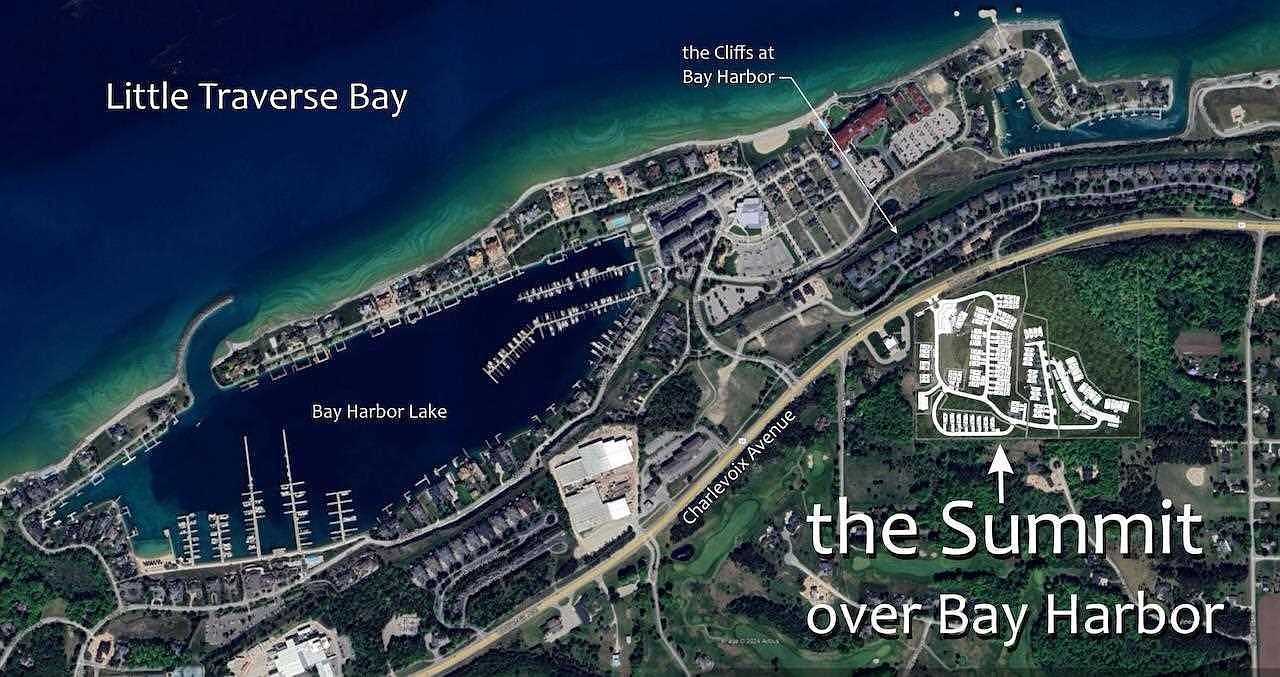 This aerial view showcases a lakeside community with a mix of residential buildings, marinas, and green spaces. The image highlights the proximity to Little Traverse Bay and Bay Harbor Lake, emphasizing the waterfront lifestyle. The layout includes various amenities and recreational areas, suggesting a well-planned and desirable living environment.
