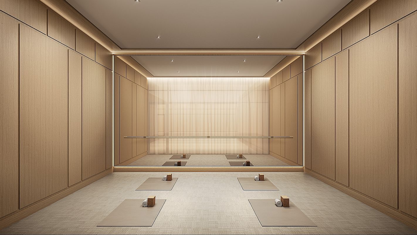 This serene home gym features light wood paneling on the walls and a neutral-toned floor, creating a minimalist and calming atmosphere. A large, wall-to-wall mirror reflects the space, which is equipped with a ballet barre and four yoga mats arranged symmetrically with blocks and rolled towels. The room is illuminated by soft, recessed lighting and integrated LED strips, providing a clean and professional aesthetic suitable for yoga or pilates.