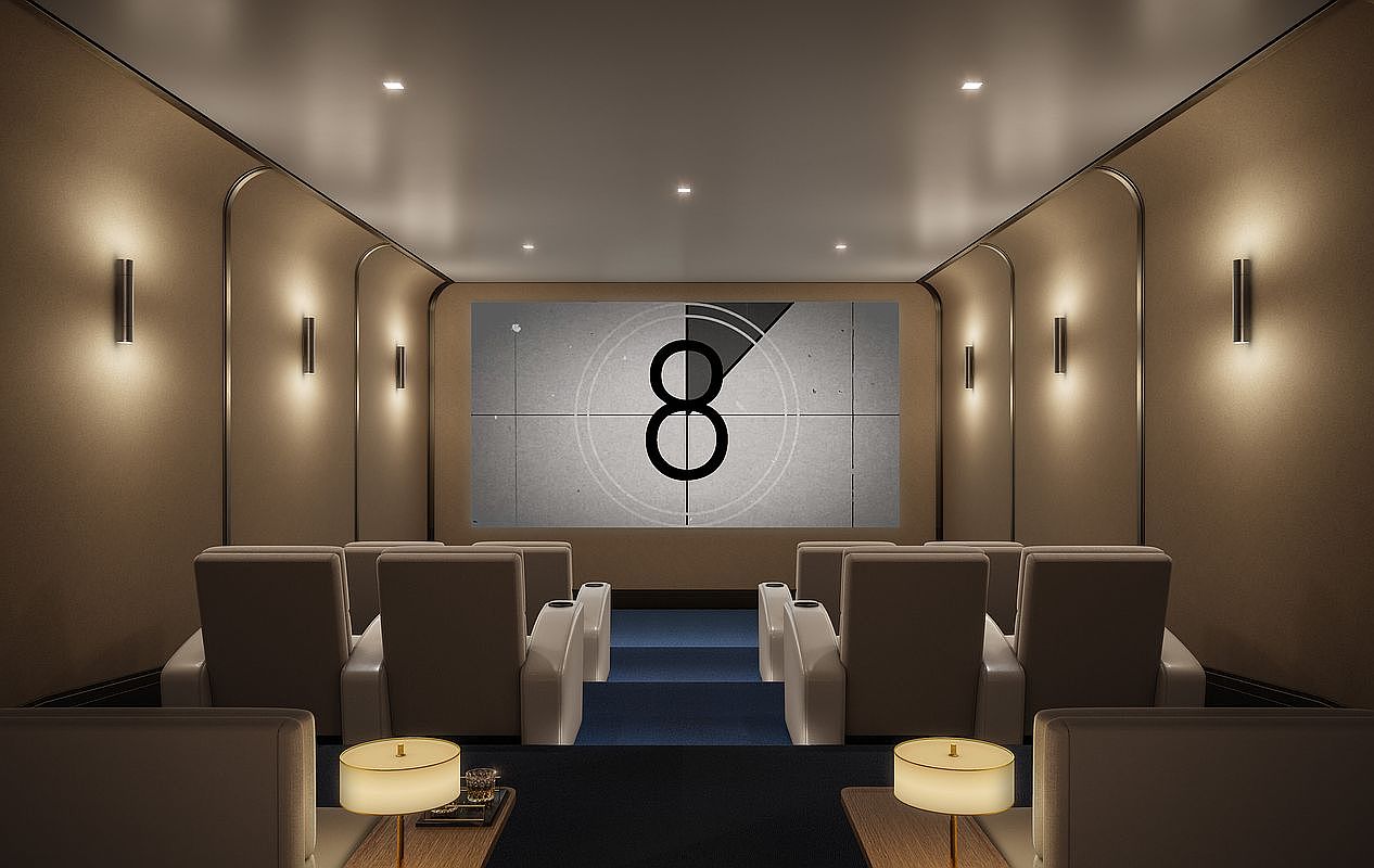 This image depicts a luxury private home theater featuring tiered seating with plush, light-colored armchairs arranged in rows. The room is designed with a sophisticated, neutral color palette, accented by warm wall-mounted lighting fixtures and a large projection screen displaying a classic film countdown. The perspective is centered and symmetrical, emphasizing the immersive cinematic experience and high-end finishes of the space.