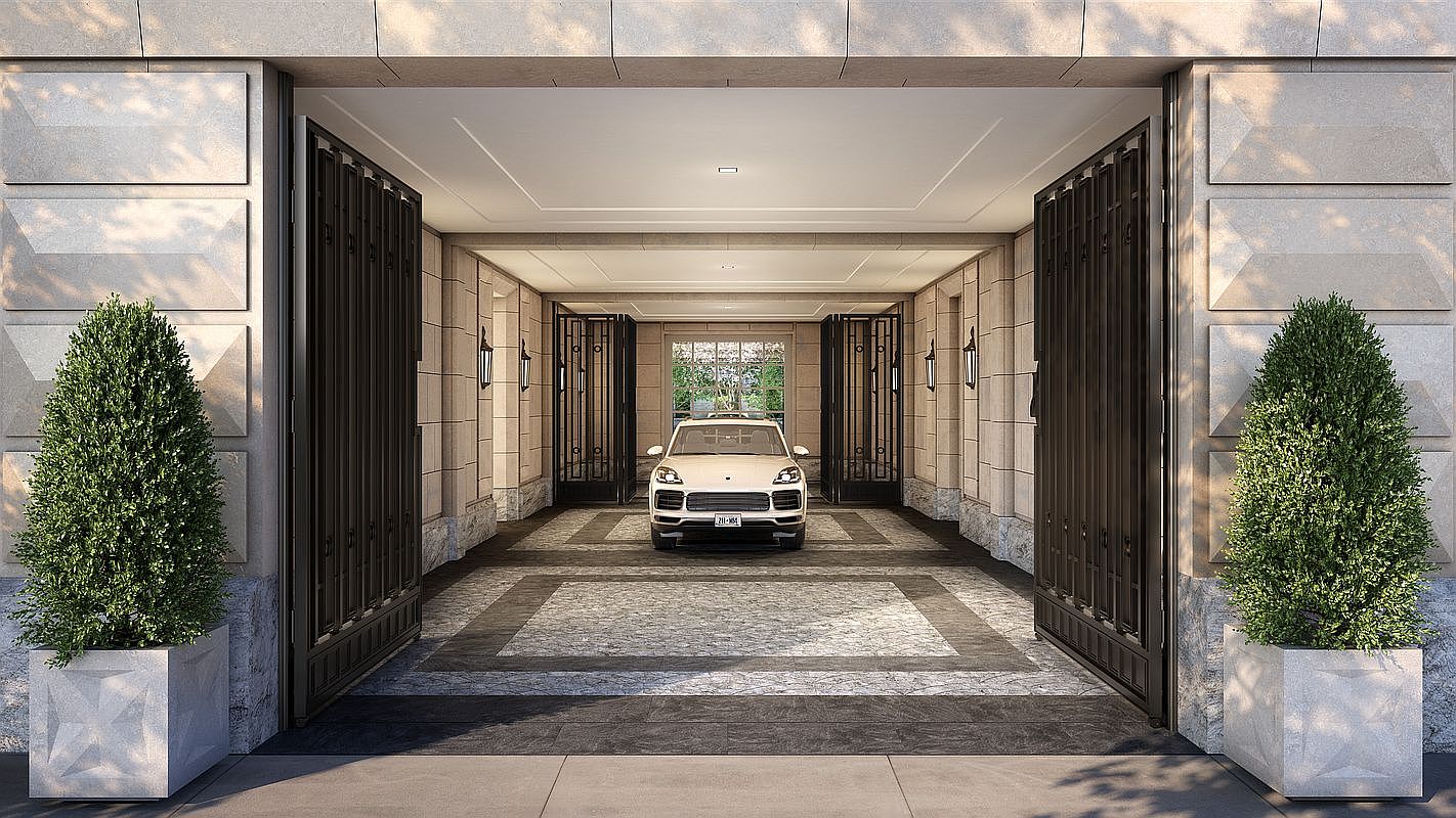 This sophisticated porte-cochère or private garage entrance features a symmetrical design with large, open metal gates and manicured topiary plants in stone planters flanking the entryway. The space is paved with intricate stone patterns and leads to a central parking area where a luxury SUV is parked, framed by elegant wall sconces and architectural stone detailing. The perspective is a centered, eye-level shot that emphasizes the grand, formal aesthetic of the property's arrival point.