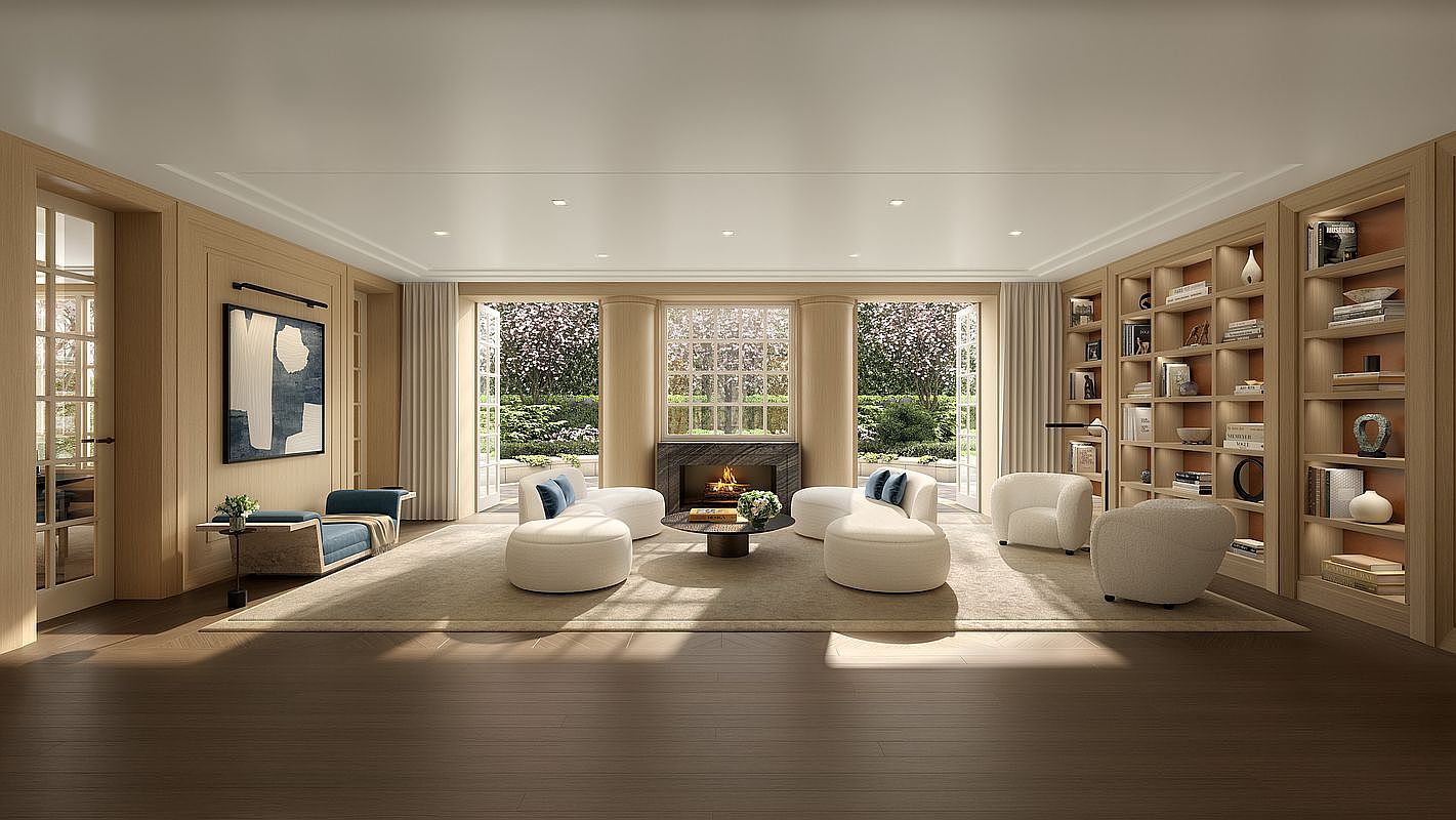 This sophisticated living room features light wood paneling, a neutral color palette, and a symmetrical layout centered around a stone-clad fireplace. The space is furnished with curved, cream-colored seating and a central coffee table, all resting on a large area rug. Large glass doors flank the fireplace, providing a clear view of the lush greenery outside and filling the room with natural light.