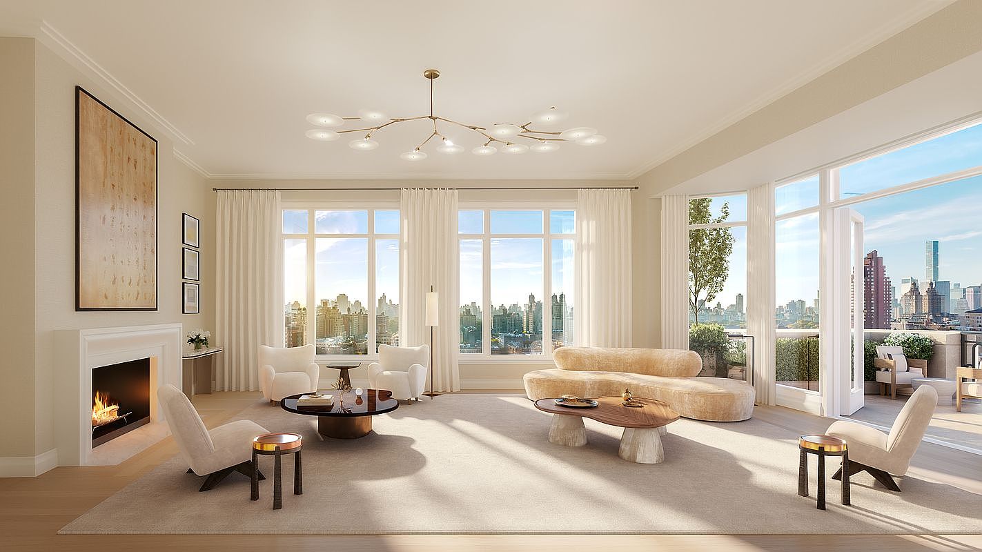 This sophisticated living room features a neutral color palette, a curved sofa, and multiple armchairs arranged around a central coffee table. A fireplace with a classic mantel serves as a focal point on the left, while large windows provide abundant natural light and expansive city views. The space is anchored by a large area rug and illuminated by a modern, branching chandelier, creating an elegant and airy atmosphere.