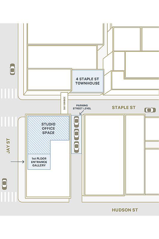 This image is a stylized, top-down architectural site map illustrating the layout of a property located at the intersection of Jay St, Staple St, and Hudson St. It highlights key features such as the '4 Staple St Townhouse,' a 'Studio Office Space,' a '1st Floor Entrance Gallery,' and a 'Sky Bridge' connecting the structures. The map also indicates street-level parking and provides a clear, simplified visual representation of the building footprints and their spatial relationship to the surrounding streets.