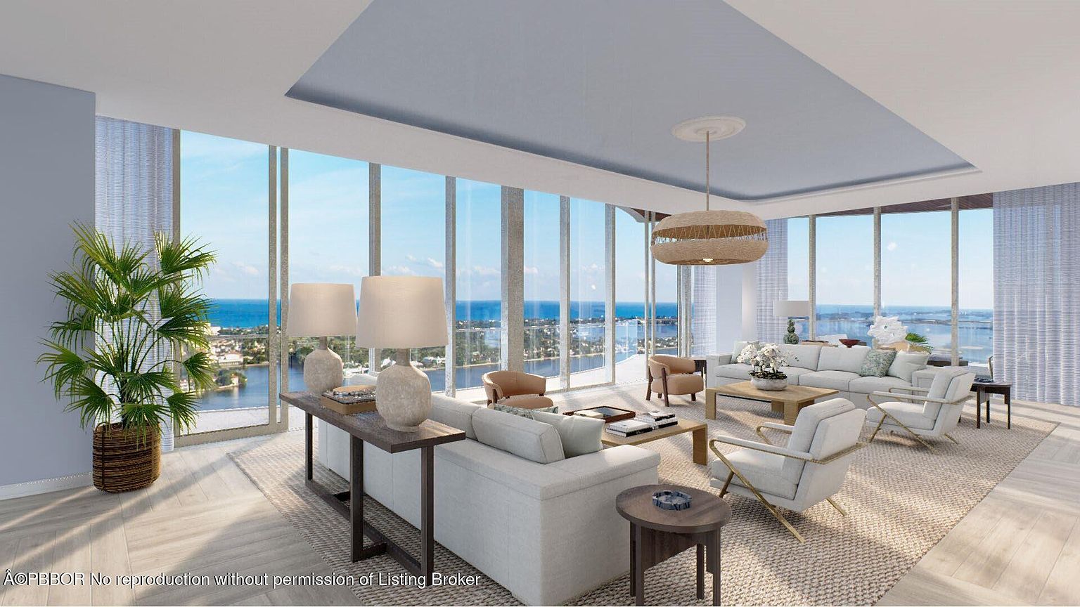 This is a bright and airy living room with floor-to-ceiling windows offering stunning ocean views. The room is furnished with comfortable white sofas, accent chairs, and stylish coffee tables, creating a luxurious and inviting atmosphere. A unique pendant light fixture hangs above, adding a touch of modern elegance.