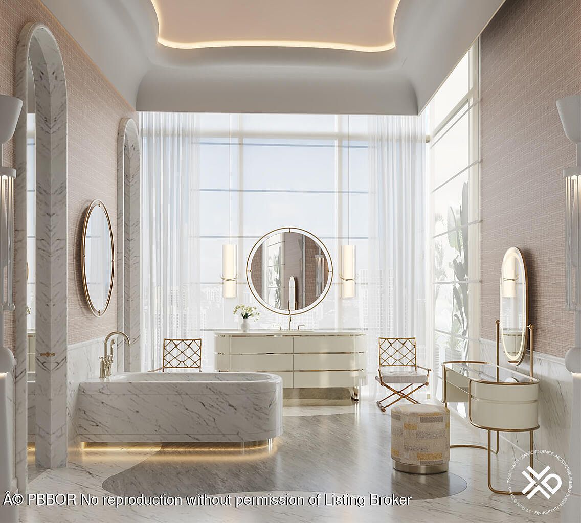 This is a luxurious primary bathroom featuring a marble bathtub with underlighting, a large window with sheer curtains, and elegant gold-accented fixtures. The bathroom includes a vanity with a round mirror, a makeup vanity with a stool, and marble archways, creating a sophisticated and spa-like atmosphere. The color palette is soft and neutral, enhancing the sense of tranquility and opulence.