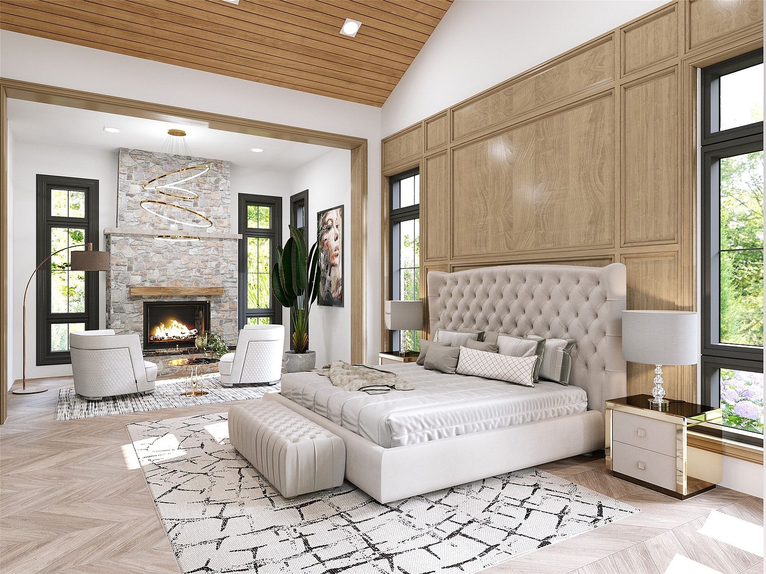 This is a luxurious primary bedroom featuring a large tufted headboard, a neutral color palette, and wood paneling on the wall. The room includes a fireplace with stone surround, comfortable seating area, and a stylish area rug. The overall impression is one of elegance and comfort.