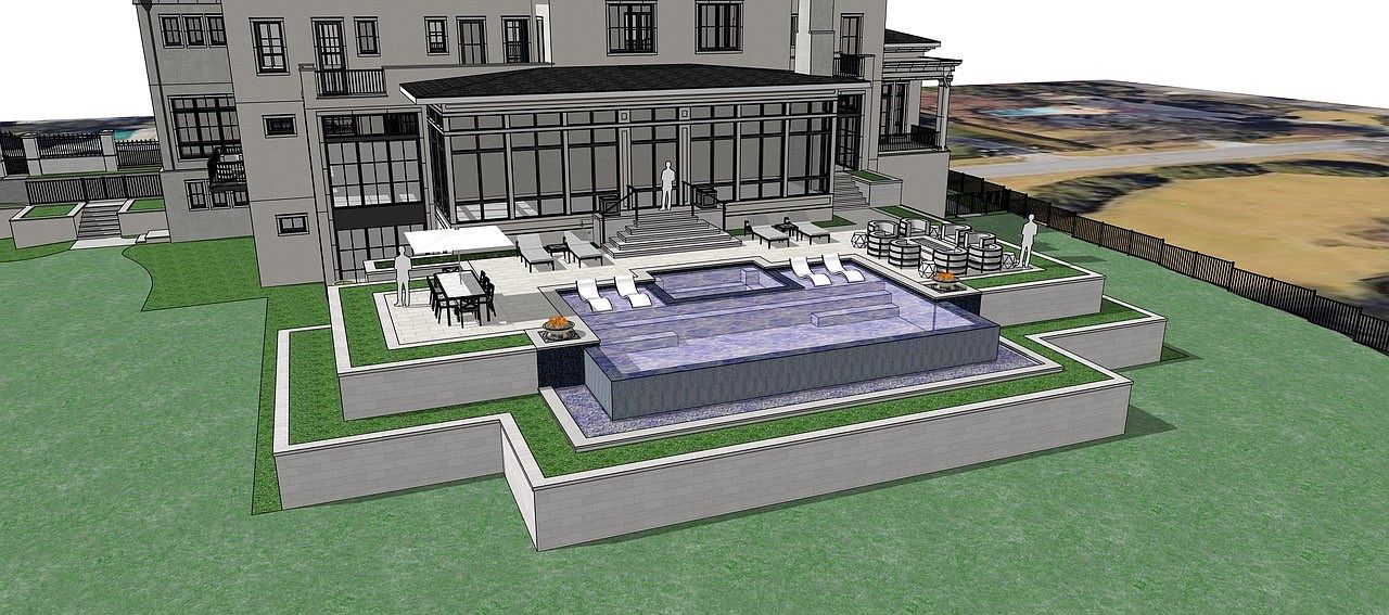 This image showcases a luxurious backyard featuring a modern pool and spa area. The pool is surrounded by tiered landscaping with lush greenery and hardscaped patios. The design includes lounge chairs, a dining area with an umbrella, and a bar area, creating an inviting outdoor living space. The perspective is from an elevated angle, providing a comprehensive view of the pool and its surrounding amenities.