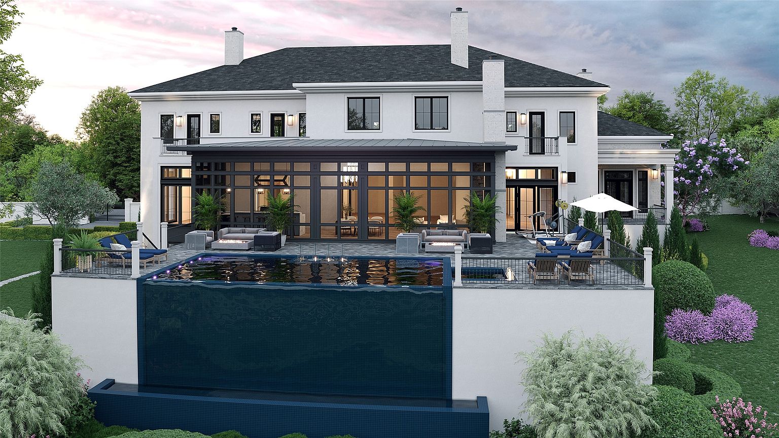 This is a rear view of a luxurious two-story home featuring a modern design with a dark roof and white exterior. The house has a large glass-enclosed sunroom or extension leading to a patio area with outdoor seating, a pool with a waterfall feature, and manicured landscaping. The perspective is from a slightly elevated position, showcasing the pool and the house's rear facade.