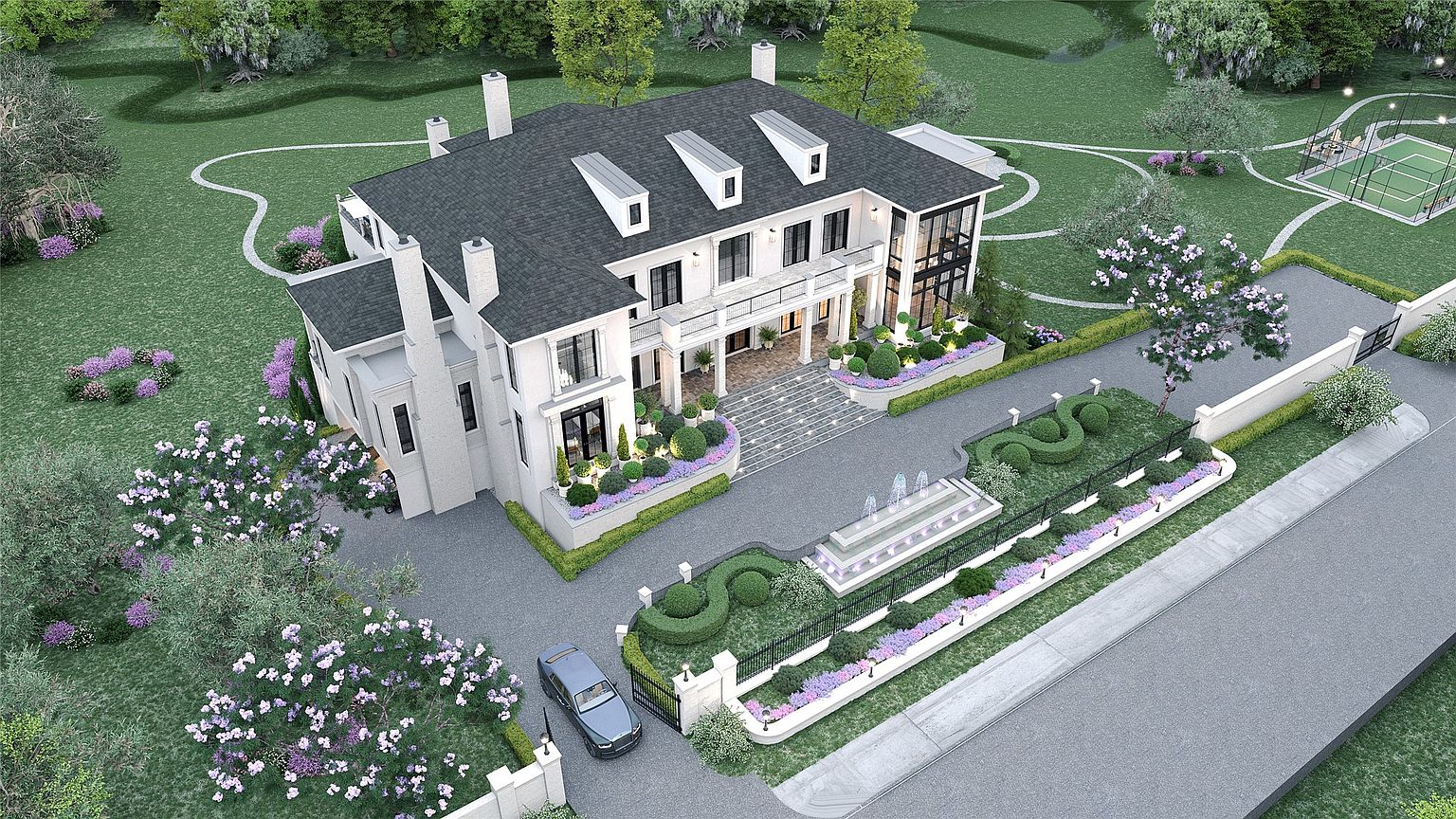 This aerial view showcases a grand, white two-story home with a dark gray roof and multiple dormers. The property features meticulously landscaped gardens, a long driveway leading to the entrance, and a tennis court in the background. The overall impression is one of luxury and sophisticated estate living.
