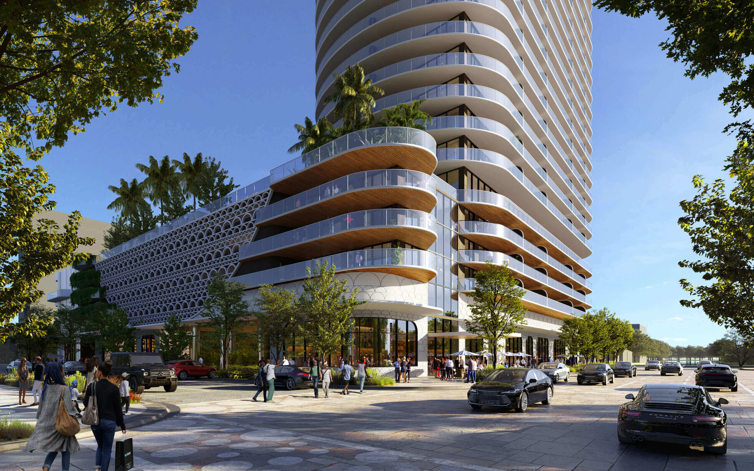 This image showcases the front view of a modern, high-rise residential building with curved balconies and glass railings. The building features a unique architectural design with a combination of concrete and glass elements, complemented by lush landscaping and palm trees. The street scene includes pedestrian activity and luxury vehicles, creating a vibrant and upscale atmosphere.