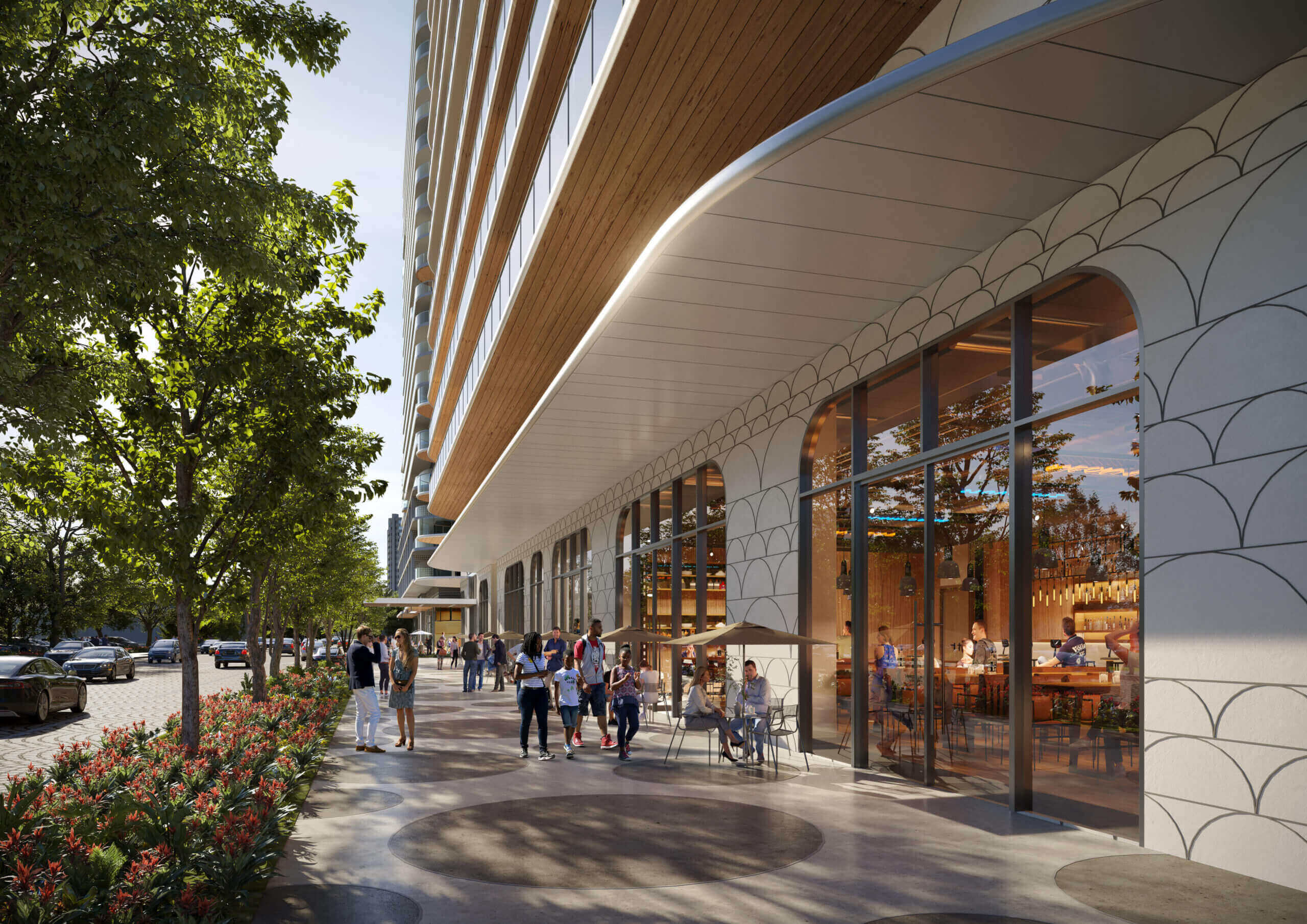 This image showcases the front exterior of a modern building with a unique architectural design. The building features a combination of glass, wood, and patterned concrete, creating a visually appealing facade. People are seen walking along the sidewalk in front of the building, suggesting a vibrant and accessible urban environment.
